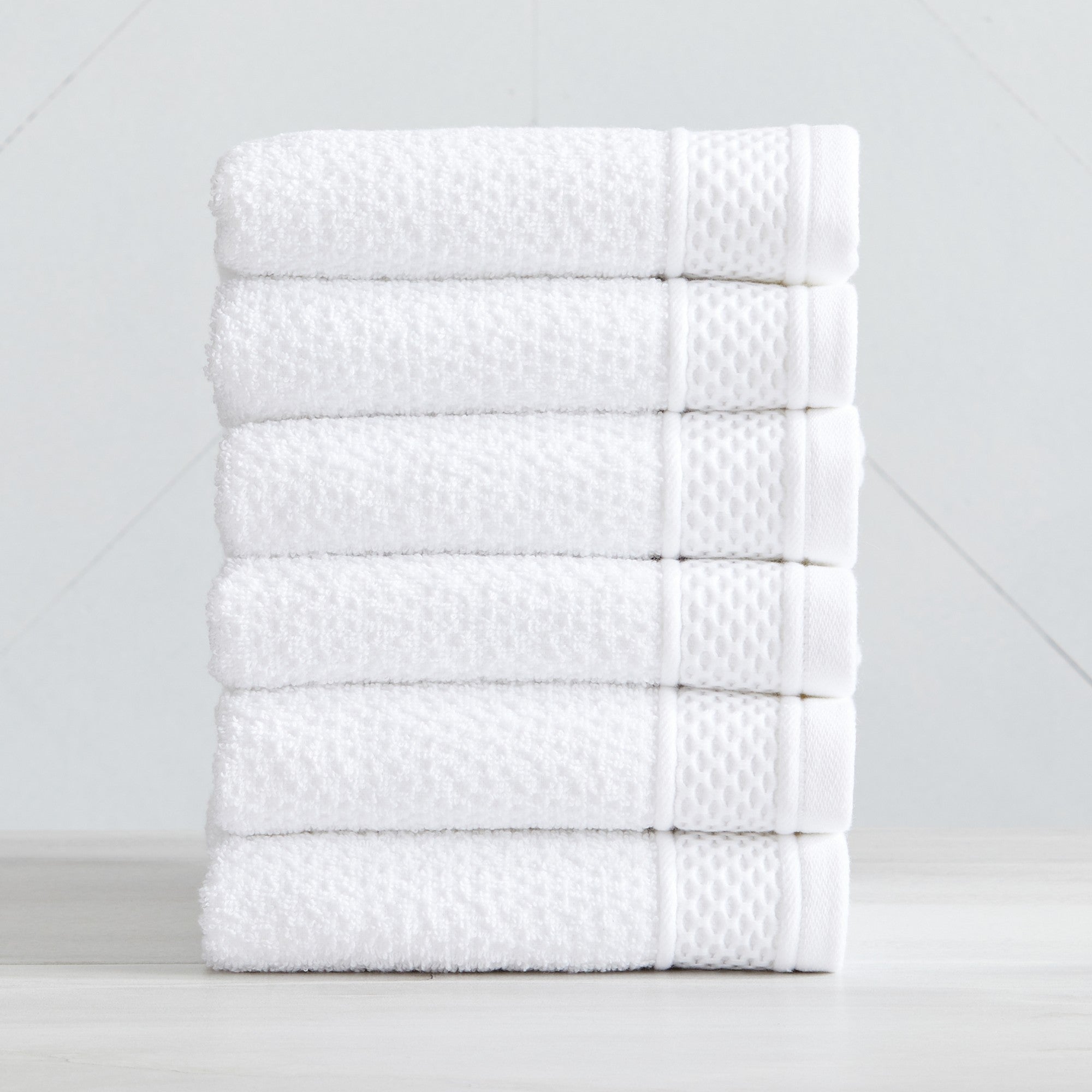 Soft and absorbent 100% cotton bath towel sets in assorted solid colors, featuring plush textures and coordinated bath towels, hand towels, and washcloths styled in bathroom and lifestyle settings.