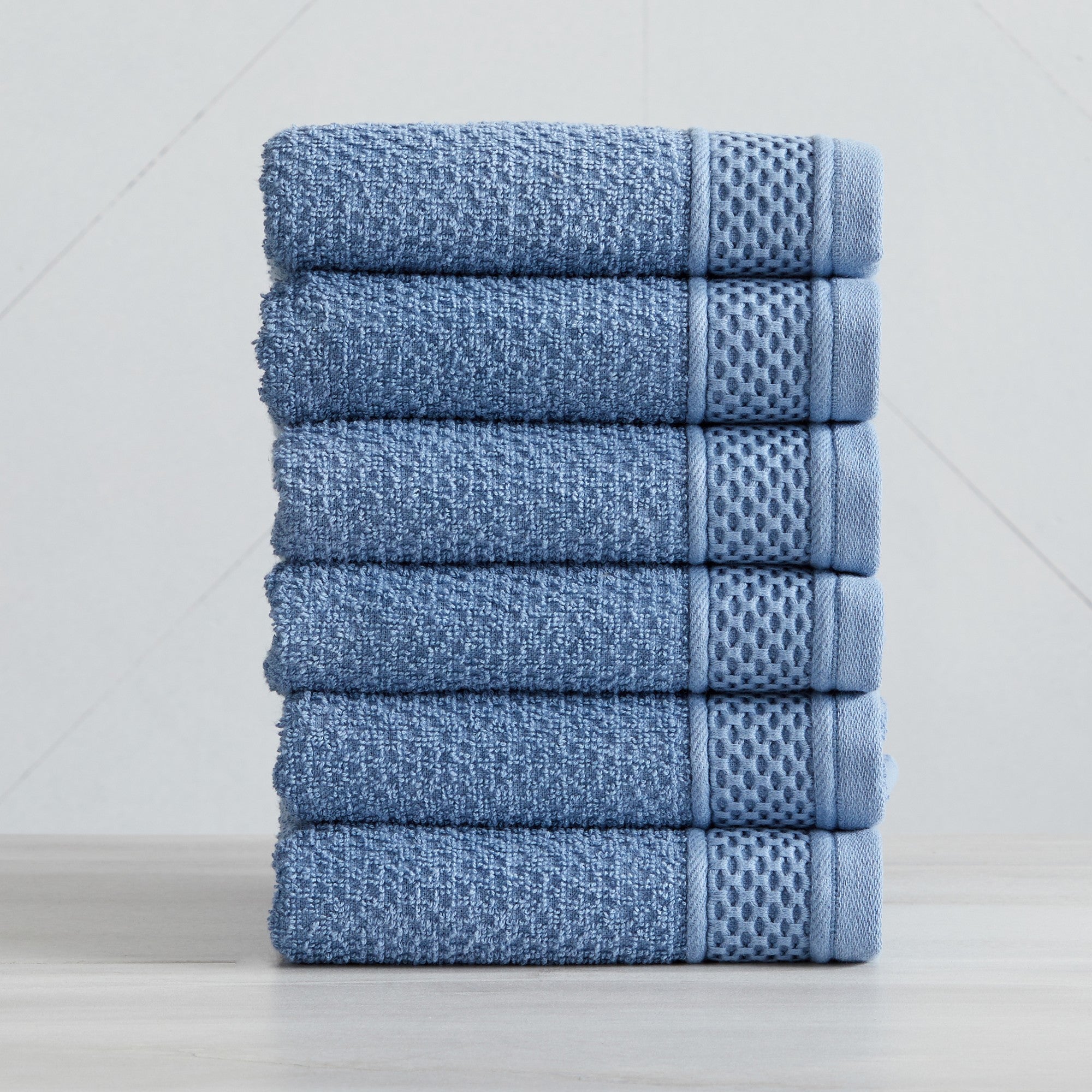 Soft and absorbent 100% cotton bath towel sets in assorted solid colors, featuring plush textures and coordinated bath towels, hand towels, and washcloths styled in bathroom and lifestyle settings.