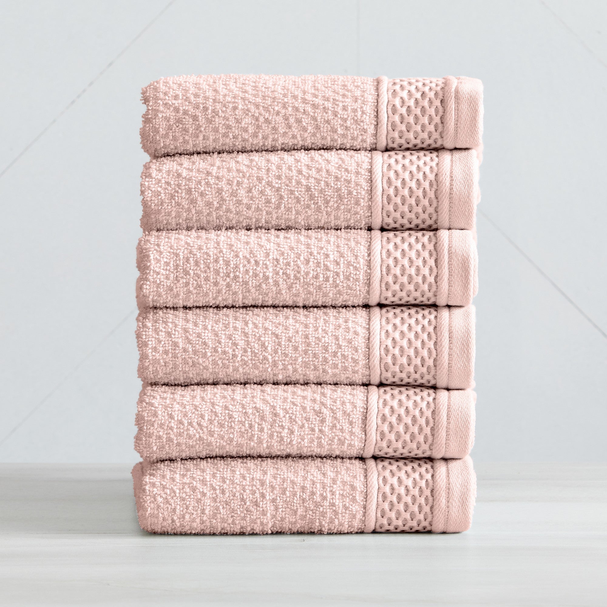 Soft and absorbent 100% cotton bath towel sets in assorted solid colors, featuring plush textures and coordinated bath towels, hand towels, and washcloths styled in bathroom and lifestyle settings.