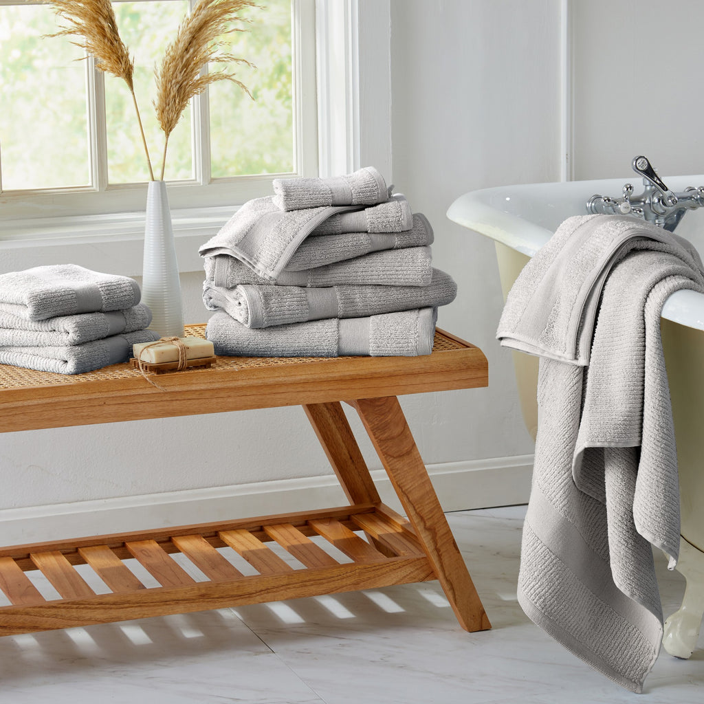 Roda Collection Cotton Ribbed Bath Towels by Market & Place featuring premium 100% cotton construction with a textured ribbed weave. Available in multiple colors and set configurations, including bath towels, hand towels, and washcloths, shown folded, stacked, and styled to highlight their soft, plush, and highly absorbent design.