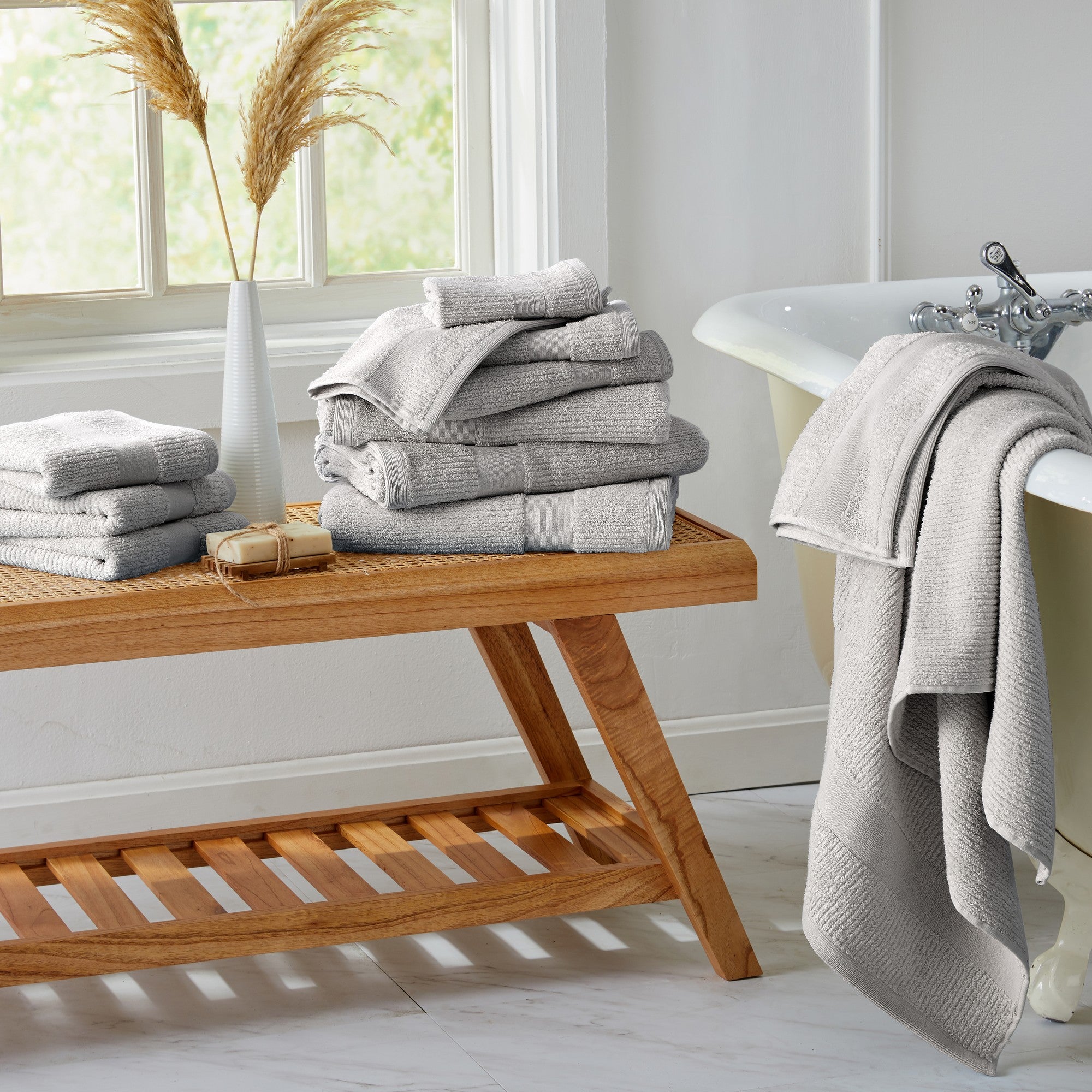 Roda Collection Cotton Ribbed Bath Towels by Market & Place featuring premium 100% cotton construction with a textured ribbed weave. Available in multiple colors and set configurations, including bath towels, hand towels, and washcloths, shown folded, stacked, and styled to highlight their soft, plush, and highly absorbent design.