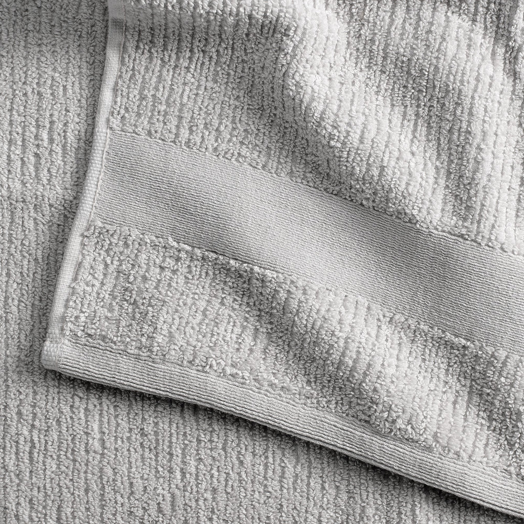 Roda Collection Cotton Ribbed Bath Towels by Market & Place featuring premium 100% cotton construction with a textured ribbed weave. Available in multiple colors and set configurations, including bath towels, hand towels, and washcloths, shown folded, stacked, and styled to highlight their soft, plush, and highly absorbent design.