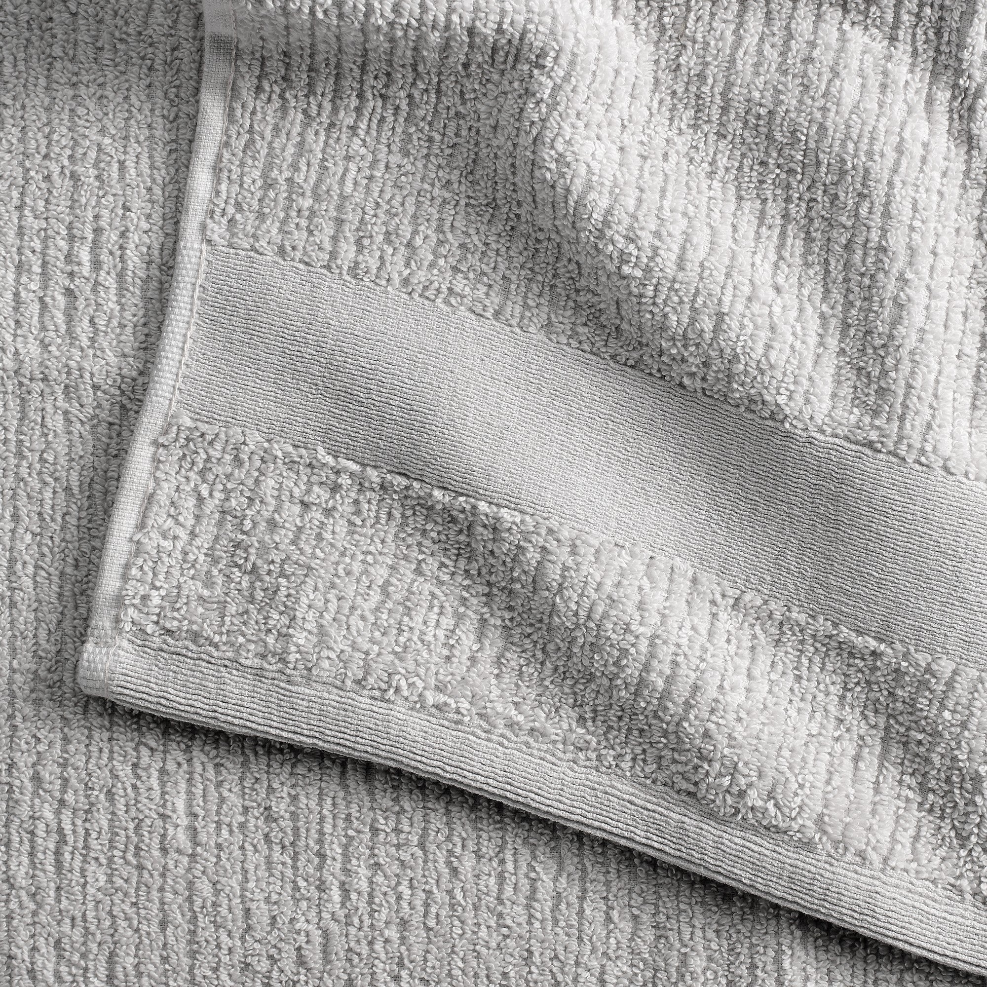 Roda Collection Cotton Ribbed Bath Towels by Market & Place featuring premium 100% cotton construction with a textured ribbed weave. Available in multiple colors and set configurations, including bath towels, hand towels, and washcloths, shown folded, stacked, and styled to highlight their soft, plush, and highly absorbent design.