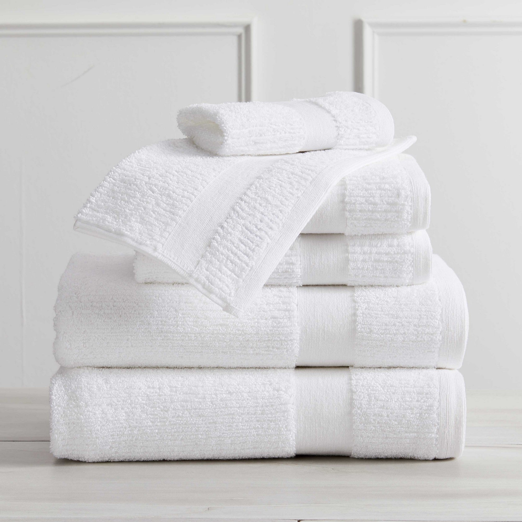 Roda Collection Cotton Ribbed Bath Towels by Market & Place featuring premium 100% cotton construction with a textured ribbed weave. Available in multiple colors and set configurations, including bath towels, hand towels, and washcloths, shown folded, stacked, and styled to highlight their soft, plush, and highly absorbent design.