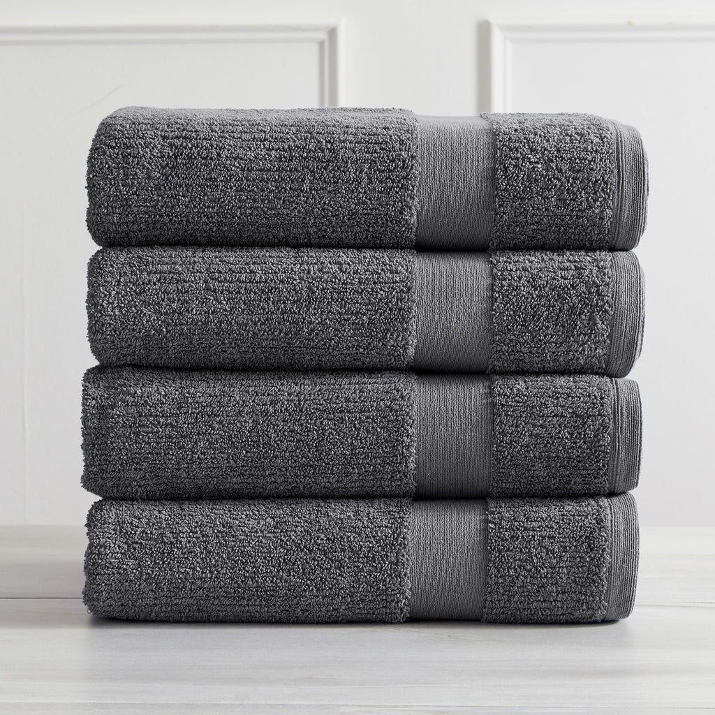 Roda Collection Cotton Ribbed Bath Towels by Market & Place featuring premium 100% cotton construction with a textured ribbed weave. Available in multiple colors and set configurations, including bath towels, hand towels, and washcloths, shown folded, stacked, and styled to highlight their soft, plush, and highly absorbent design.