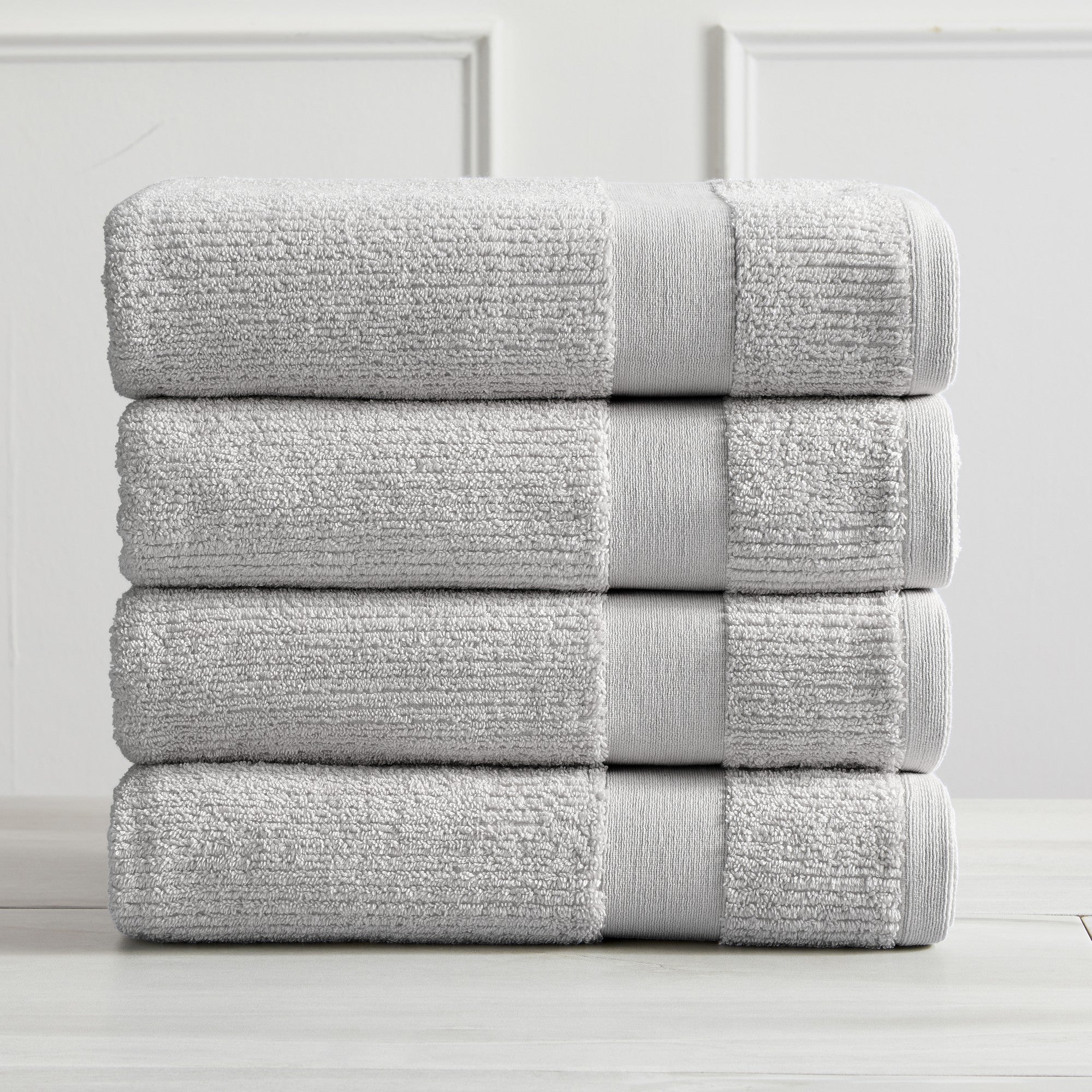 Roda Collection Cotton Ribbed Bath Towels by Market & Place featuring premium 100% cotton construction with a textured ribbed weave. Available in multiple colors and set configurations, including bath towels, hand towels, and washcloths, shown folded, stacked, and styled to highlight their soft, plush, and highly absorbent design.