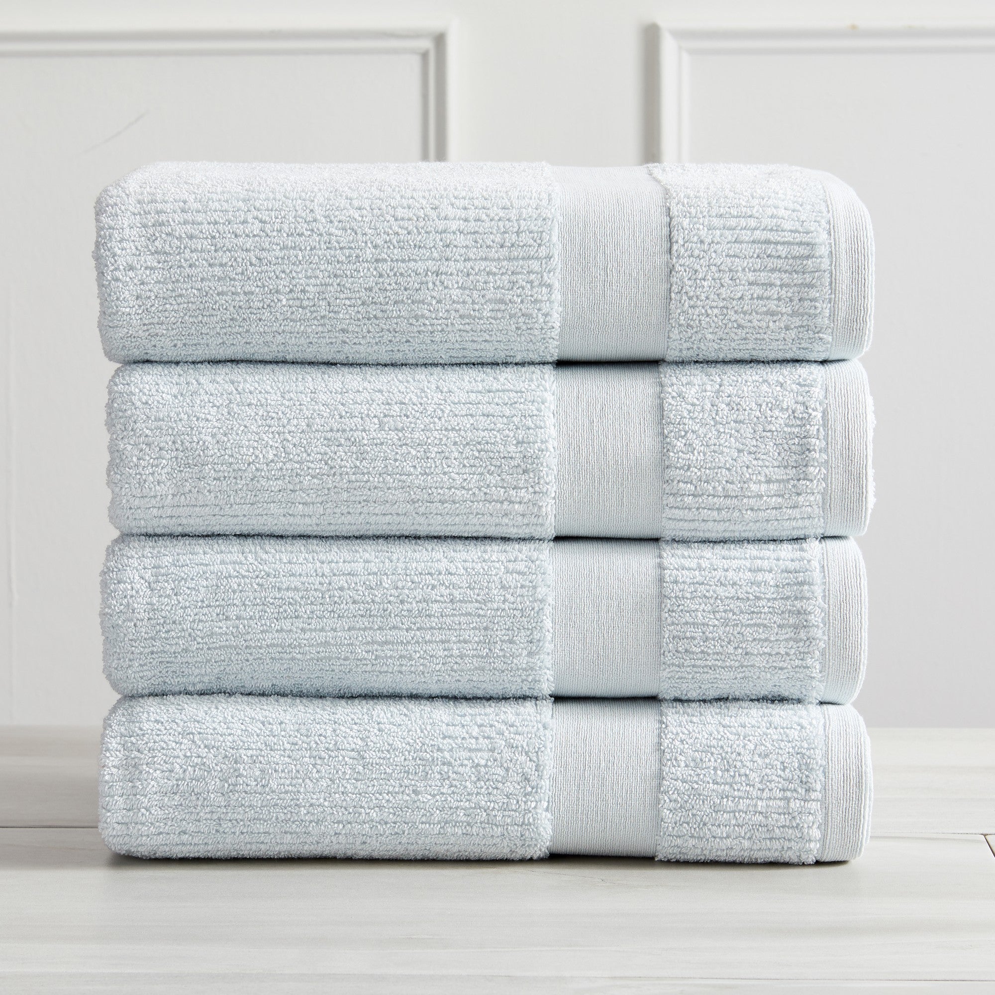 Roda Collection Cotton Ribbed Bath Towels by Market & Place featuring premium 100% cotton construction with a textured ribbed weave. Available in multiple colors and set configurations, including bath towels, hand towels, and washcloths, shown folded, stacked, and styled to highlight their soft, plush, and highly absorbent design.