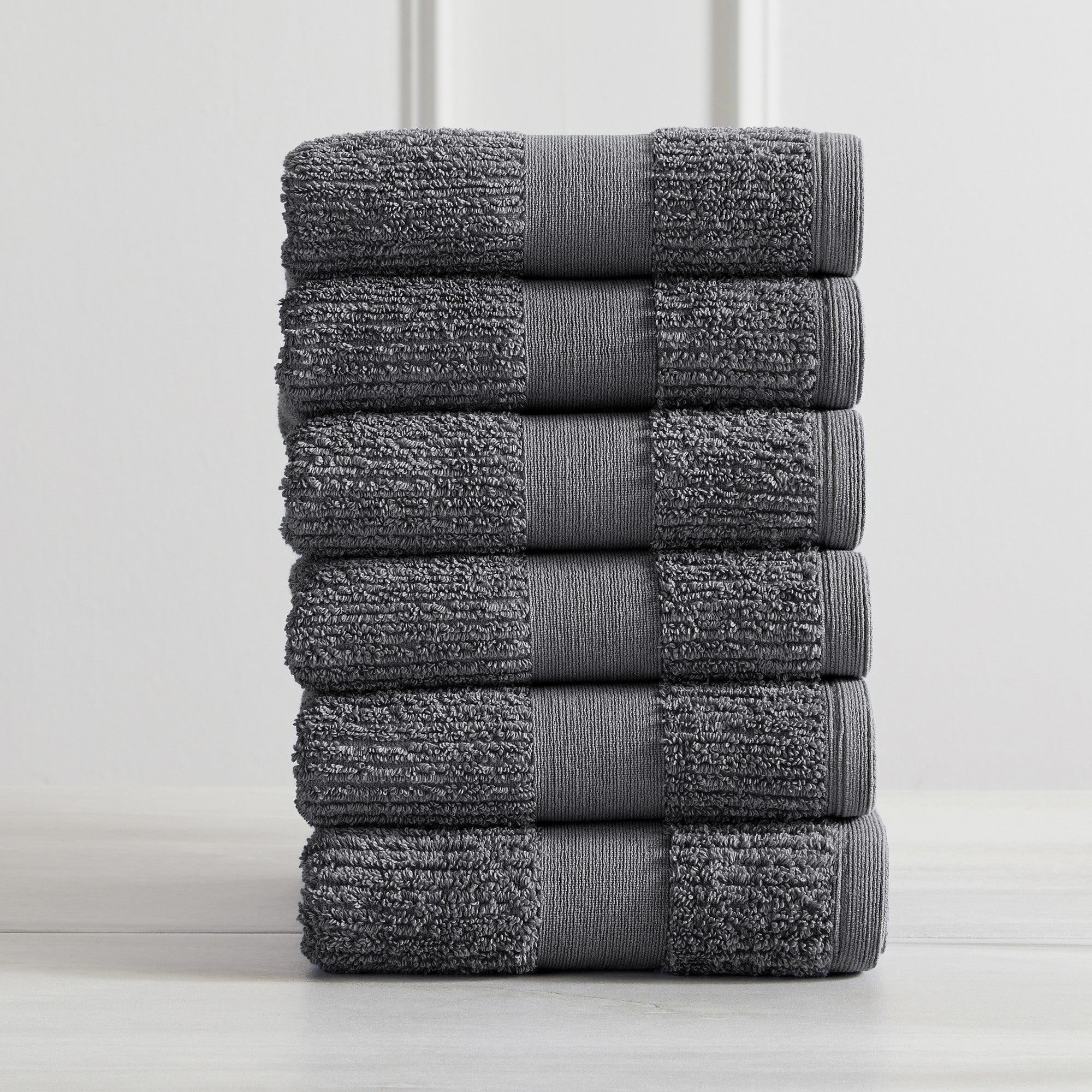 Roda Collection Cotton Ribbed Bath Towels by Market & Place featuring premium 100% cotton construction with a textured ribbed weave. Available in multiple colors and set configurations, including bath towels, hand towels, and washcloths, shown folded, stacked, and styled to highlight their soft, plush, and highly absorbent design.