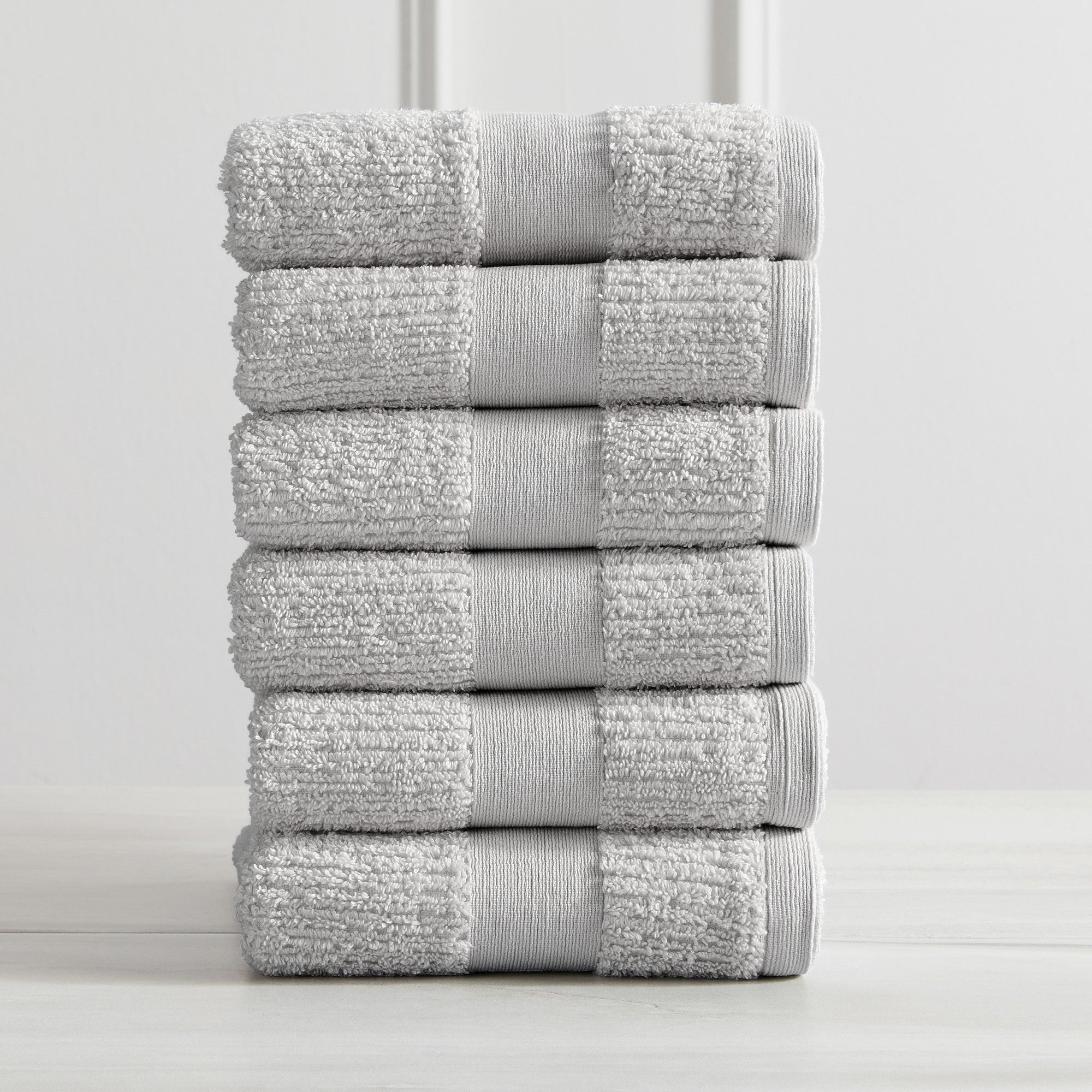 Roda Collection Cotton Ribbed Bath Towels by Market & Place featuring premium 100% cotton construction with a textured ribbed weave. Available in multiple colors and set configurations, including bath towels, hand towels, and washcloths, shown folded, stacked, and styled to highlight their soft, plush, and highly absorbent design.