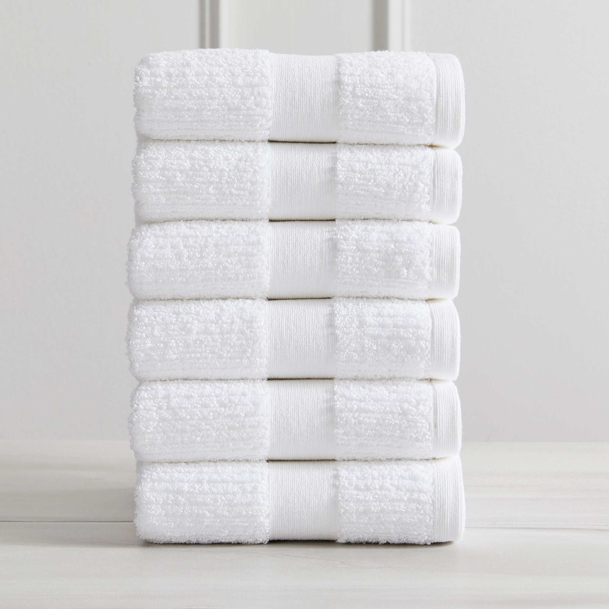 Roda Collection Cotton Ribbed Bath Towels by Market & Place featuring premium 100% cotton construction with a textured ribbed weave. Available in multiple colors and set configurations, including bath towels, hand towels, and washcloths, shown folded, stacked, and styled to highlight their soft, plush, and highly absorbent design.
