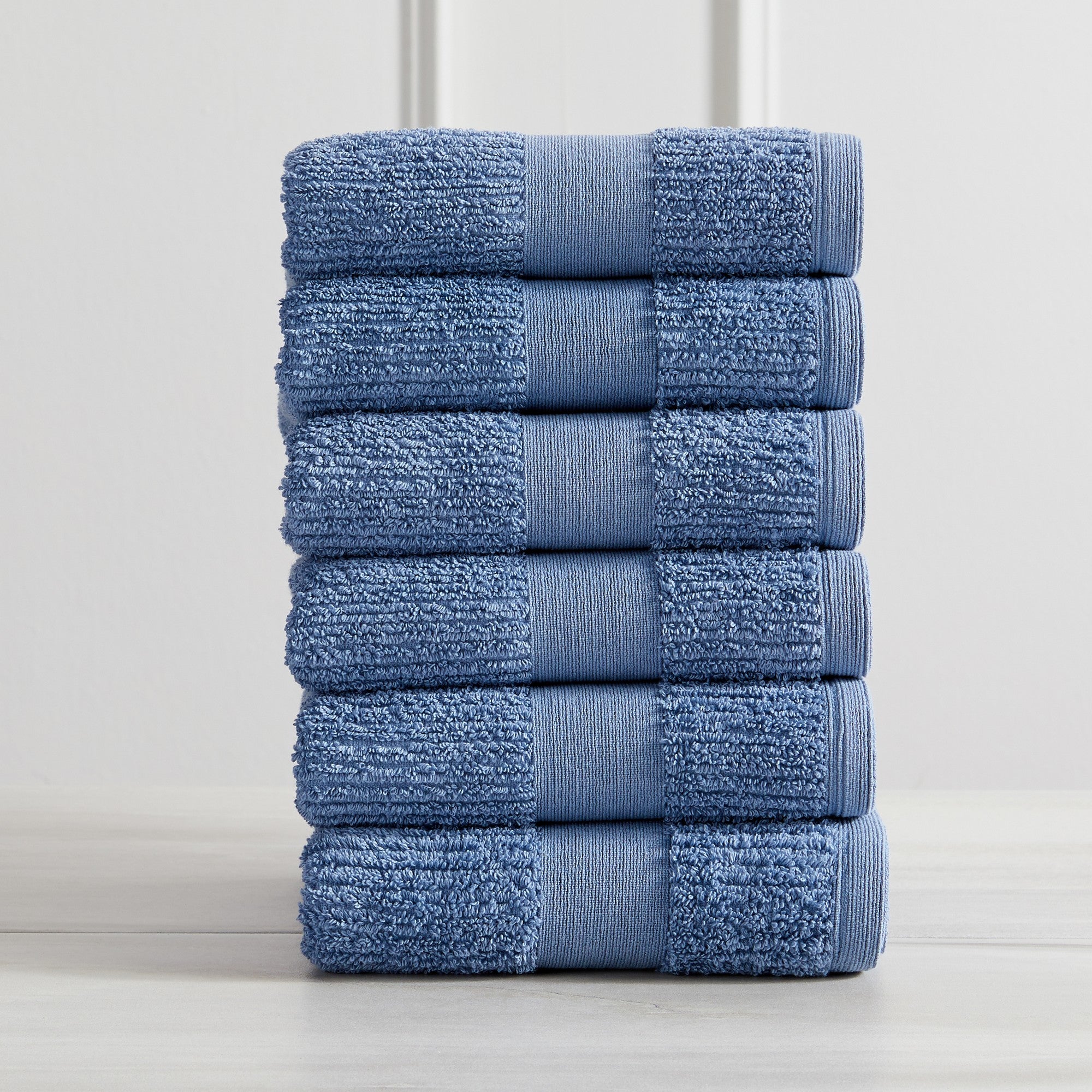 Roda Collection Cotton Ribbed Bath Towels by Market & Place featuring premium 100% cotton construction with a textured ribbed weave. Available in multiple colors and set configurations, including bath towels, hand towels, and washcloths, shown folded, stacked, and styled to highlight their soft, plush, and highly absorbent design.