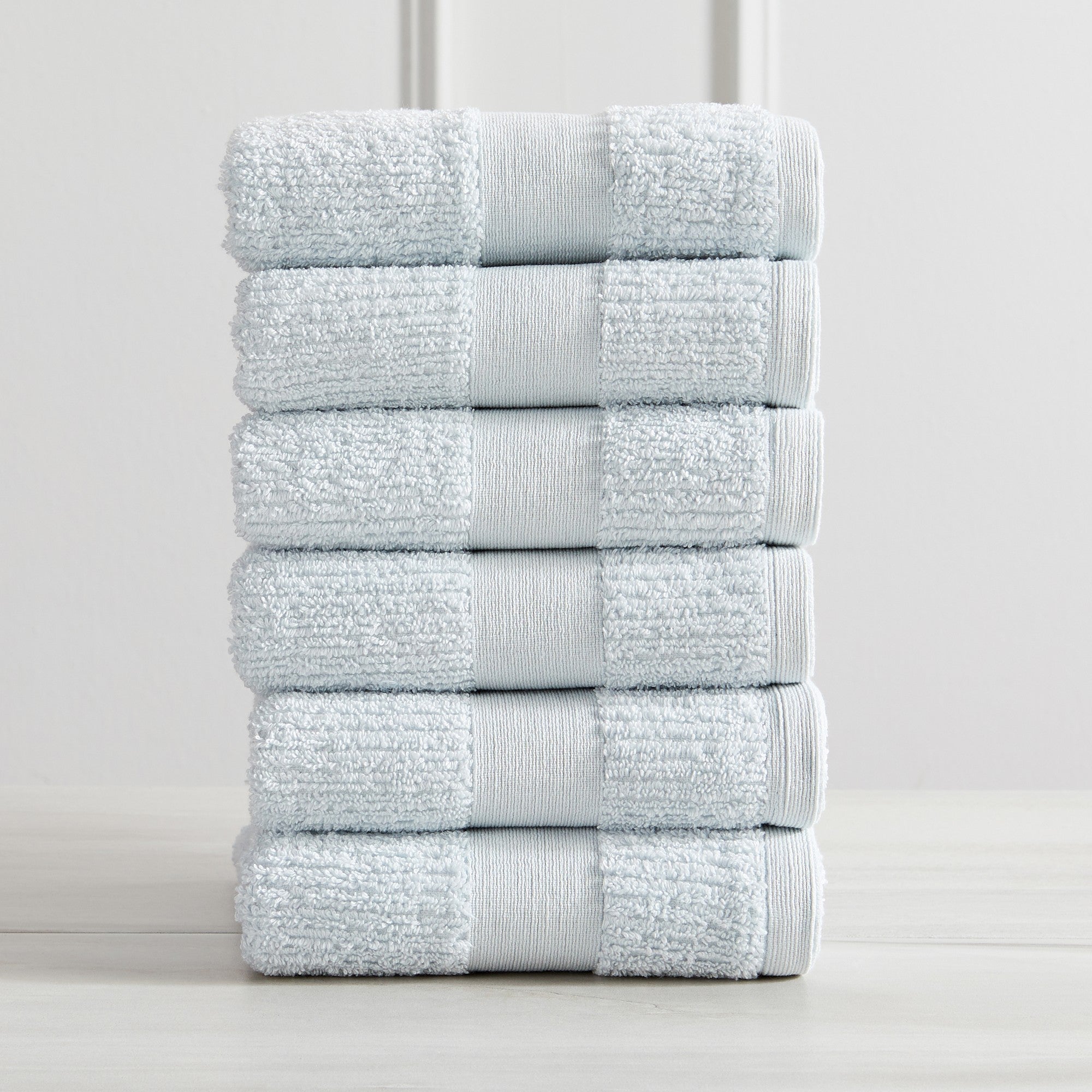 Roda Collection Cotton Ribbed Bath Towels by Market & Place featuring premium 100% cotton construction with a textured ribbed weave. Available in multiple colors and set configurations, including bath towels, hand towels, and washcloths, shown folded, stacked, and styled to highlight their soft, plush, and highly absorbent design.