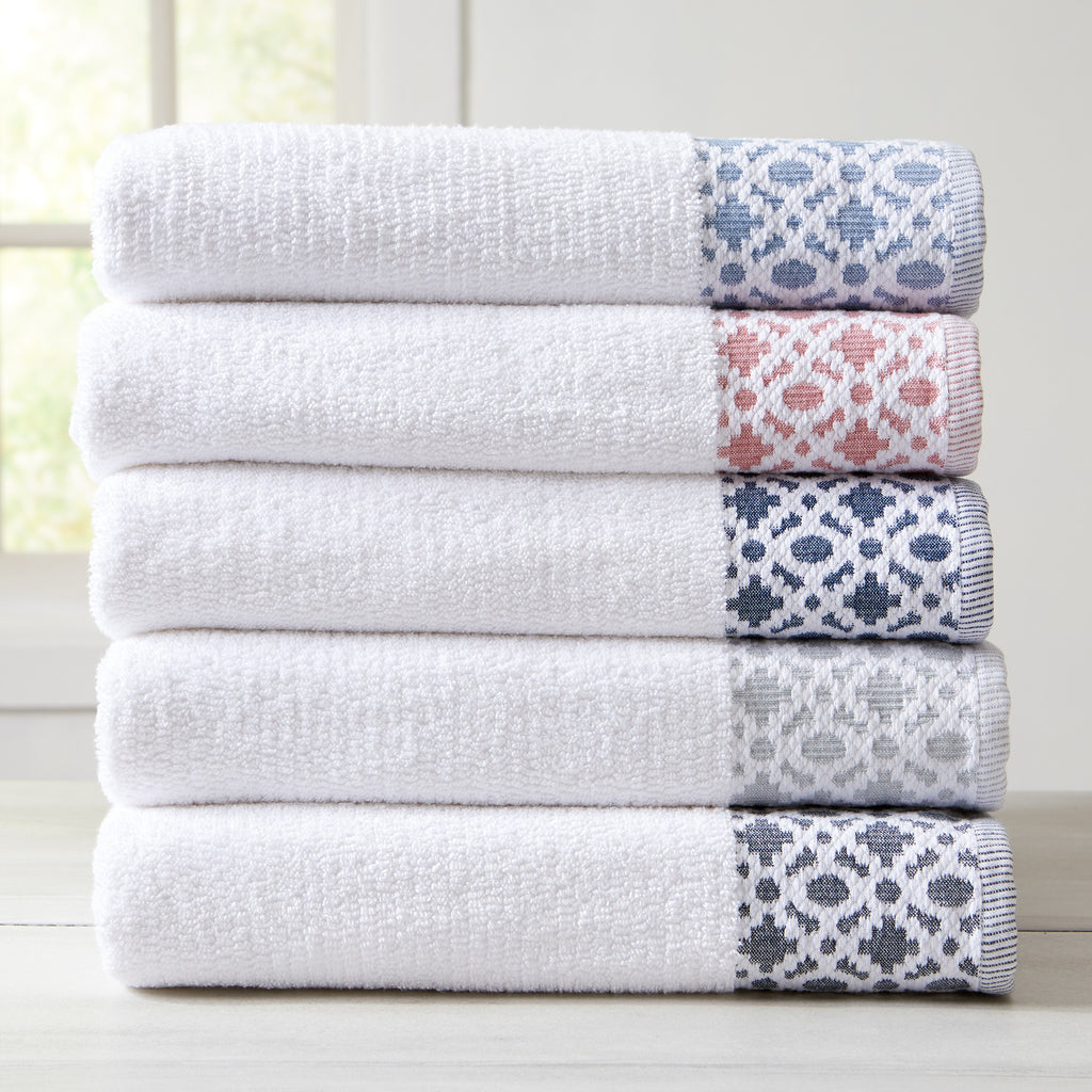 Nitra Collection Cotton Luxury Bath Towels by Market & Place featuring premium 100% cotton construction with an elegant geometric dobby border. Available in multiple colors and set configurations, including bath towels, hand towels, and washcloths, shown folded and stacked to highlight their soft, plush, and absorbent texture.