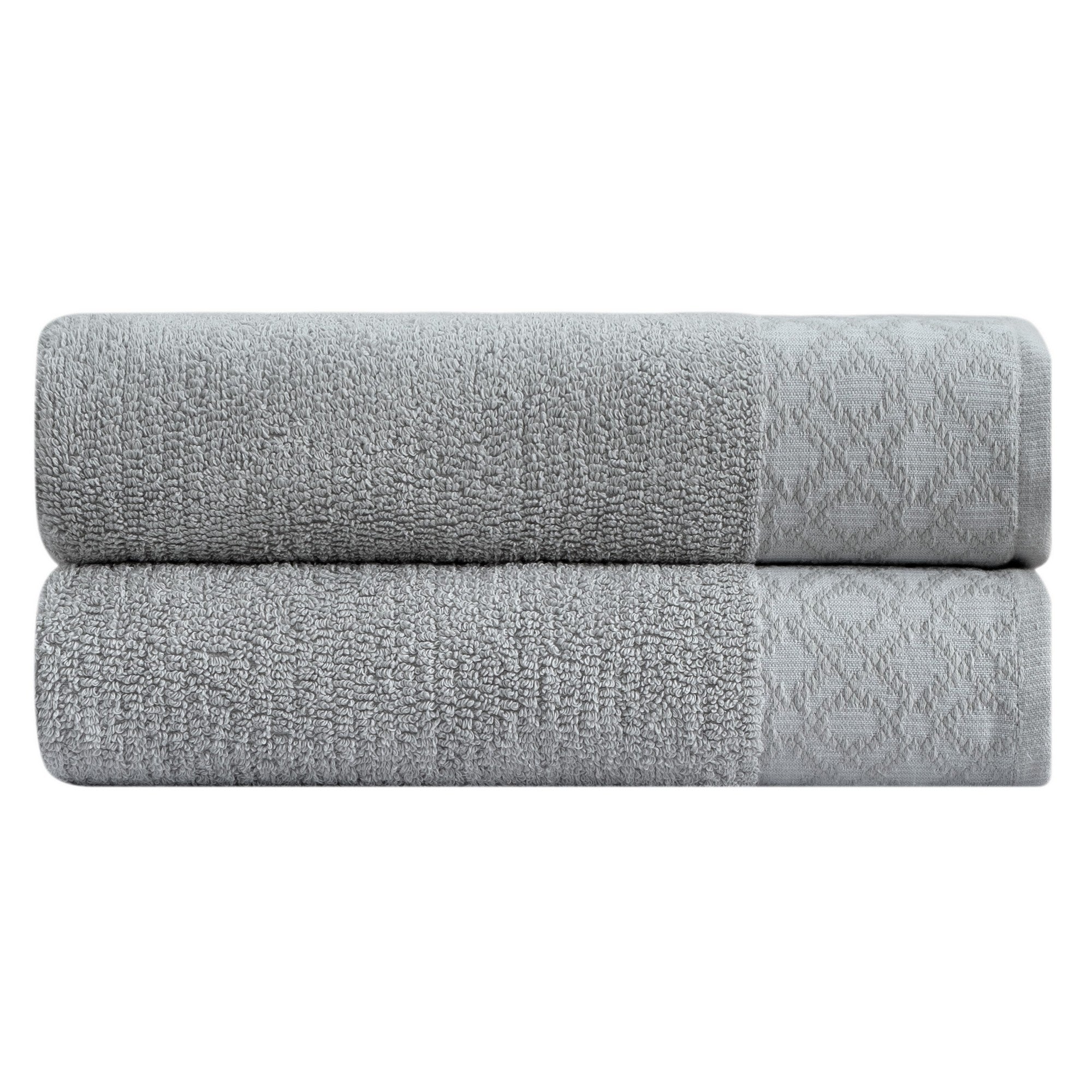 Nitra Collection Cotton Luxury Bath Towels by Market & Place featuring premium 100% cotton construction with an elegant geometric dobby border. Available in multiple colors and set configurations, including bath towels, hand towels, and washcloths, shown folded and stacked to highlight their soft, plush, and absorbent texture.