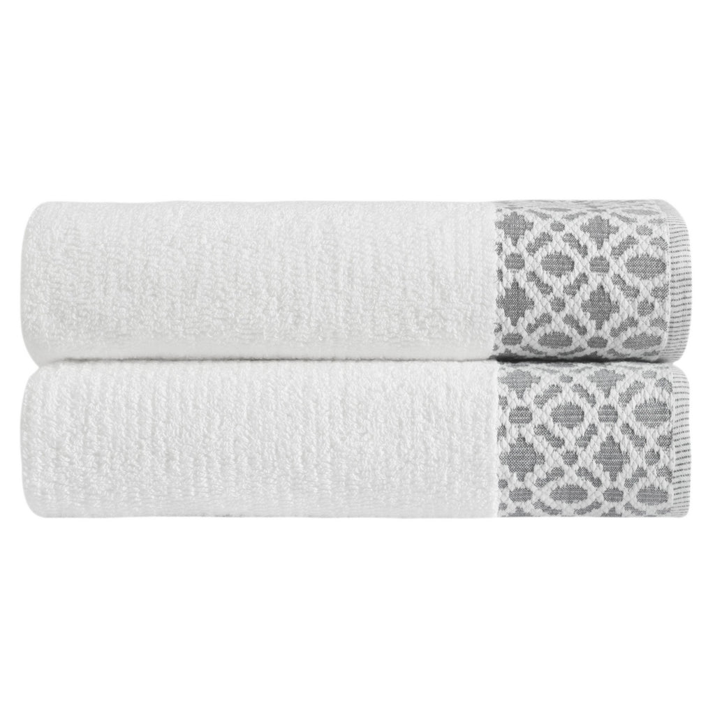 Nitra Collection Cotton Luxury Bath Towels by Market & Place featuring premium 100% cotton construction with an elegant geometric dobby border. Available in multiple colors and set configurations, including bath towels, hand towels, and washcloths, shown folded and stacked to highlight their soft, plush, and absorbent texture.