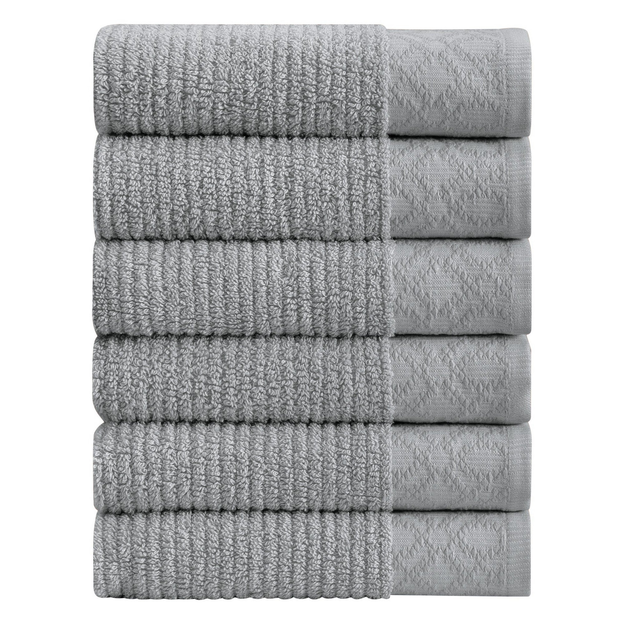 Nitra Collection Cotton Luxury Bath Towels by Market & Place featuring premium 100% cotton construction with an elegant geometric dobby border. Available in multiple colors and set configurations, including bath towels, hand towels, and washcloths, shown folded and stacked to highlight their soft, plush, and absorbent texture.