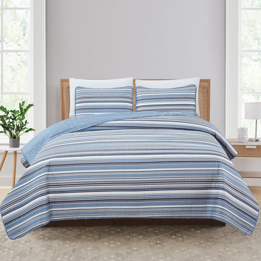 Elise Collection striped quilt set featuring classic blue and gray stripe patterns with a coordinating floral reverse, shown in multiple styling views and close-up detail shots. Soft, reversible bedding with matching shams, designed for year-round comfort and casual bedroom décor.