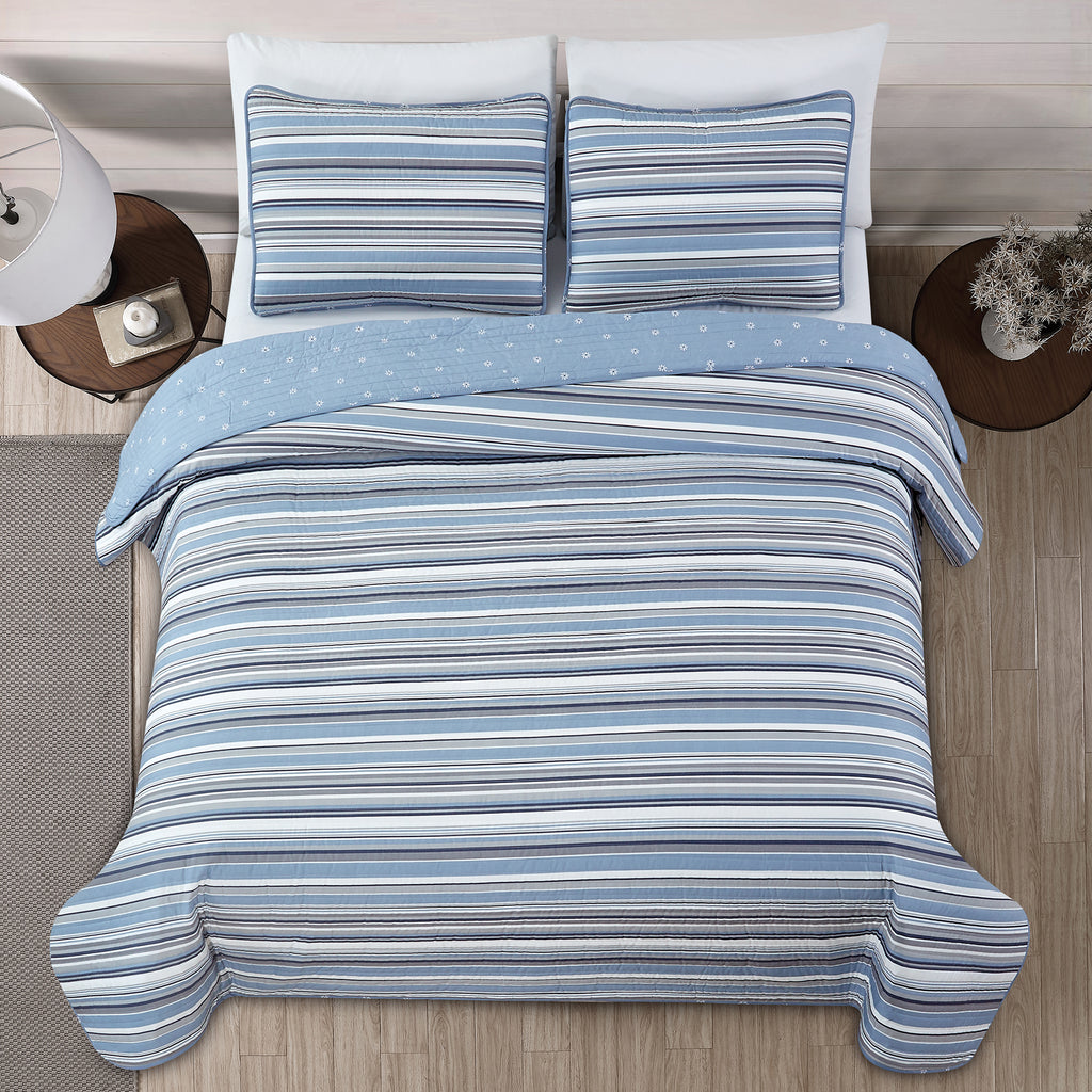 Elise Collection striped quilt set featuring classic blue and gray stripe patterns with a coordinating floral reverse, shown in multiple styling views and close-up detail shots. Soft, reversible bedding with matching shams, designed for year-round comfort and casual bedroom décor.