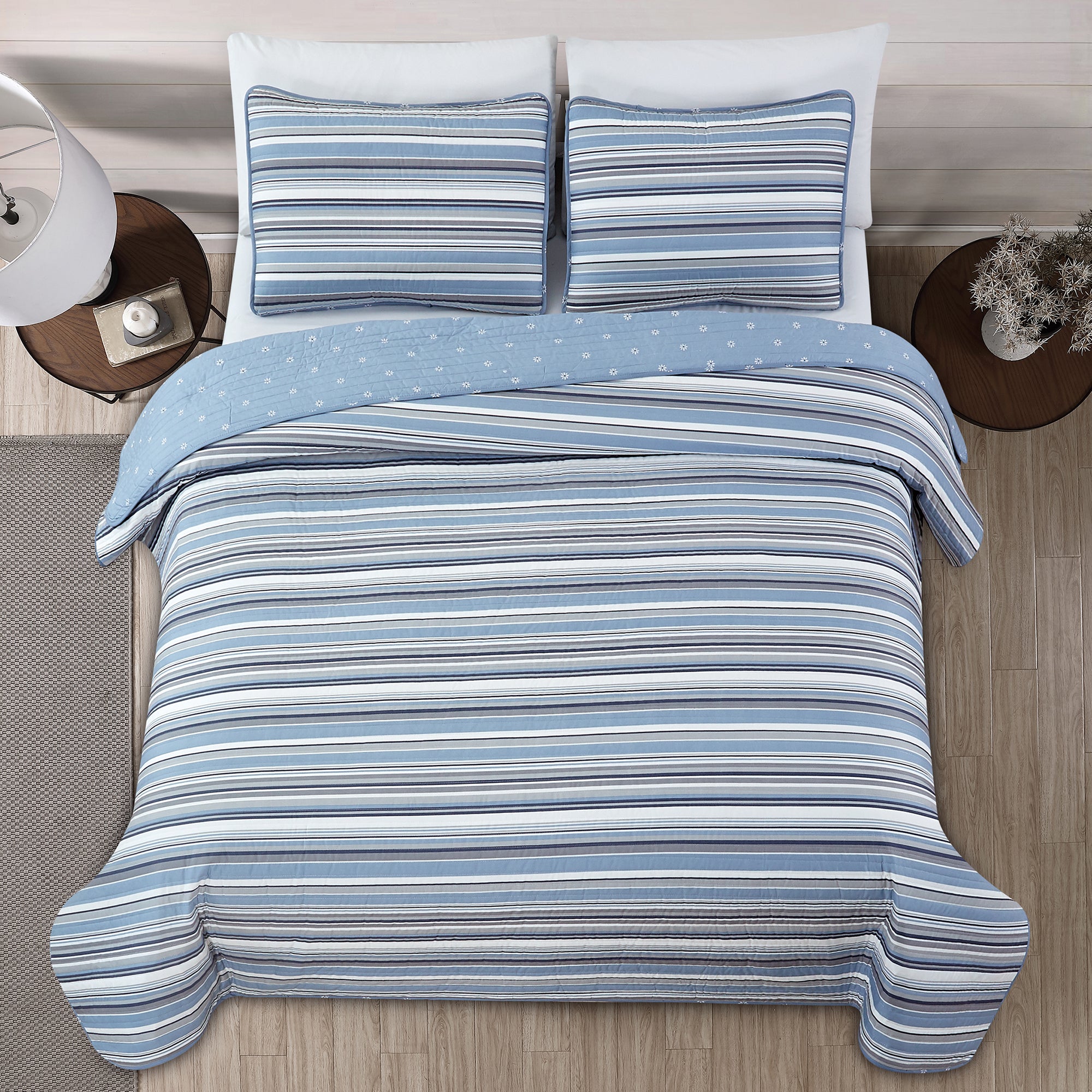 Elise Collection striped quilt set featuring classic blue and gray stripe patterns with a coordinating floral reverse, shown in multiple styling views and close-up detail shots. Soft, reversible bedding with matching shams, designed for year-round comfort and casual bedroom décor.