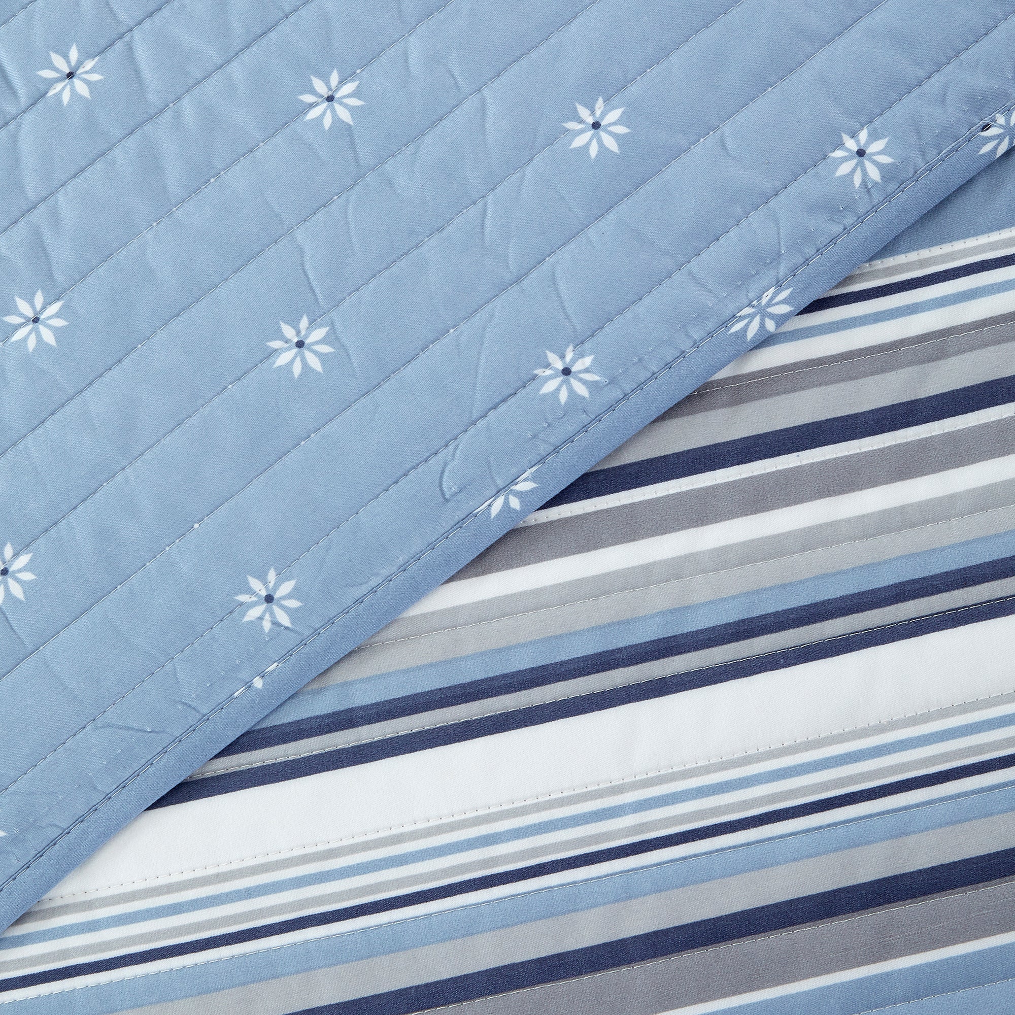 Elise Collection striped quilt set featuring classic blue and gray stripe patterns with a coordinating floral reverse, shown in multiple styling views and close-up detail shots. Soft, reversible bedding with matching shams, designed for year-round comfort and casual bedroom décor.