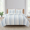 Sofia Collection striped quilt set featuring classic blue and white stripes with a reversible design, shown on beds and in close-up detail views. Soft, lightweight bedding with coordinating shams, styled in a bright and casual bedroom setting.