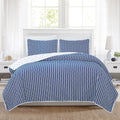Nora Collection striped quilt set featuring classic striped patterns with a reversible dotted design, shown in multiple colorways and styling views. Soft, lightweight bedding with coordinating shams, displayed on beds and in close-up detail shots.