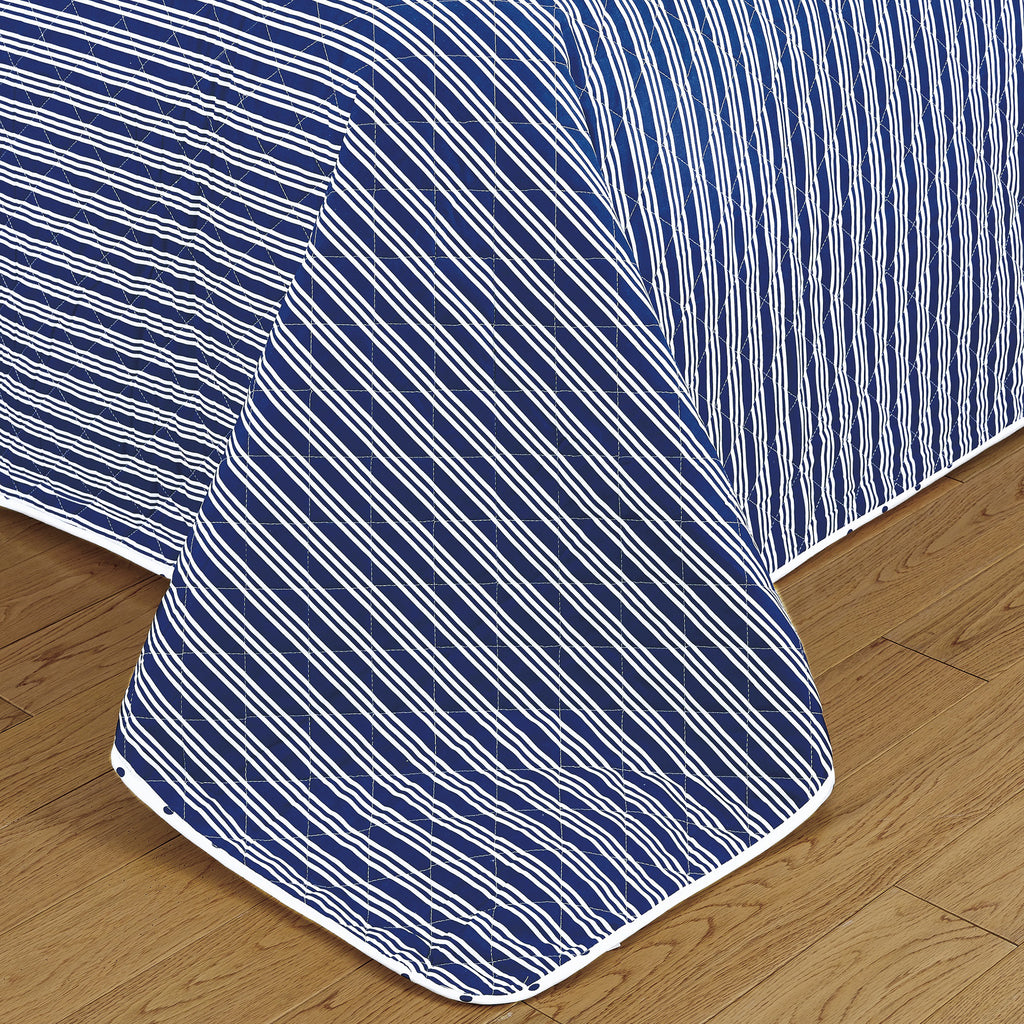 Nora Collection striped quilt set featuring classic striped patterns with a reversible dotted design, shown in multiple colorways and styling views. Soft, lightweight bedding with coordinating shams, displayed on beds and in close-up detail shots.