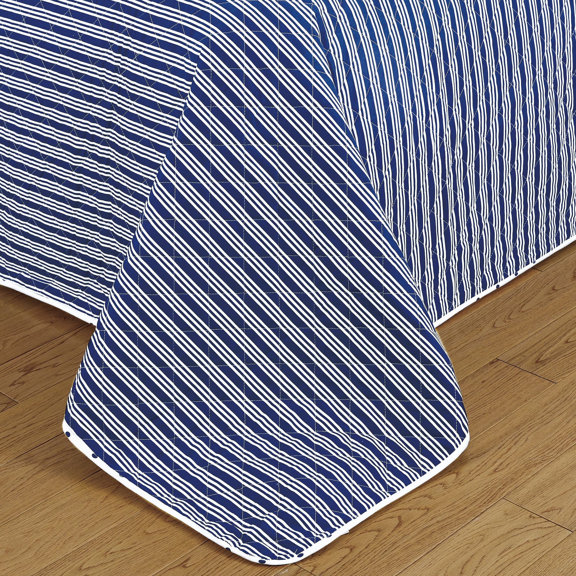 Nora Collection striped quilt set featuring classic striped patterns with a reversible dotted design, shown in multiple colorways and styling views. Soft, lightweight bedding with coordinating shams, displayed on beds and in close-up detail shots.