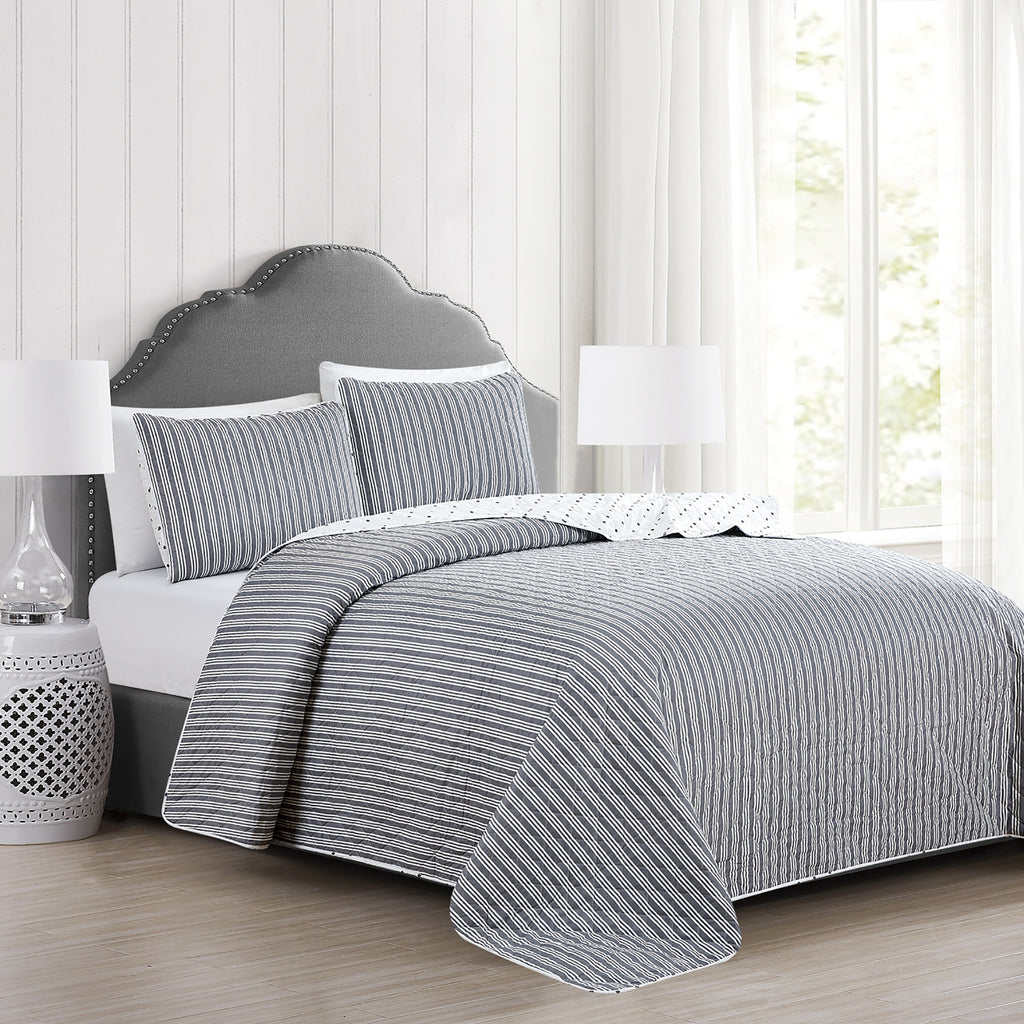 Nora Collection striped quilt set featuring classic striped patterns with a reversible dotted design, shown in multiple colorways and styling views. Soft, lightweight bedding with coordinating shams, displayed on beds and in close-up detail shots.