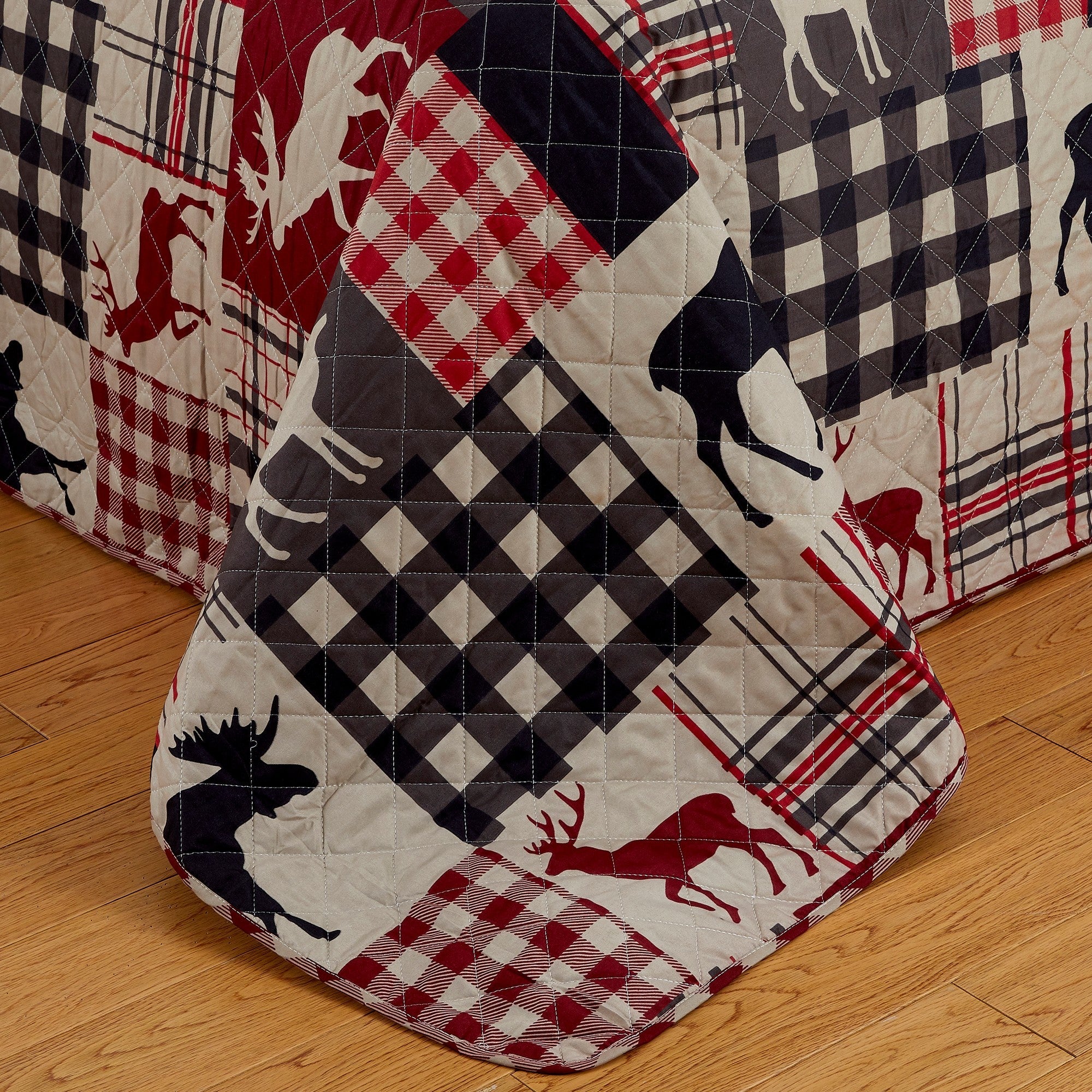 Reversible lodge quilt set featuring rustic plaid patterns and woodland-inspired motifs. Crafted with a soft microfiber shell and cotton-rich fill, this cozy bedding set includes matching sham(s) and brings cabin-inspired style to any bedroom.