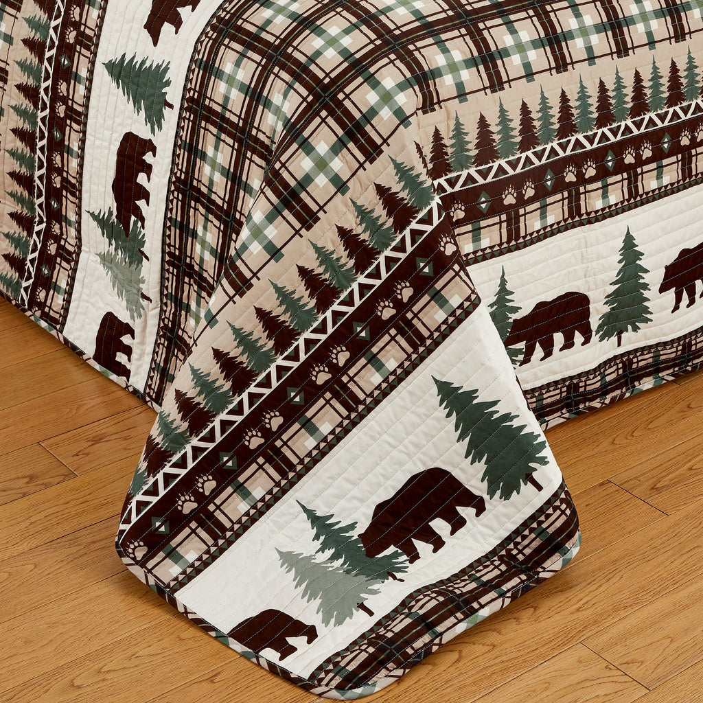 Cedar Creek Collection Lodge Quilt Set featuring rustic woodland-inspired patterns with bears, deer, trees, and plaid accents, shown in multiple colorways and styling views. Soft, reversible bedding with coordinating shams, displayed on beds and in close-up detail shots.