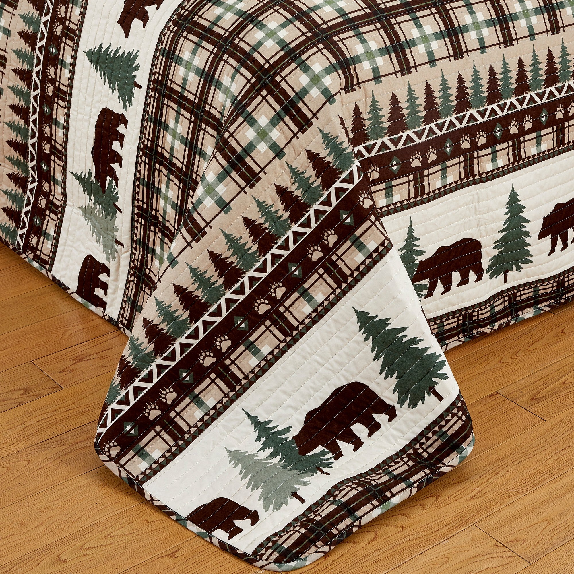 Cedar Creek Collection Lodge Quilt Set featuring rustic woodland-inspired patterns with bears, deer, trees, and plaid accents, shown in multiple colorways and styling views. Soft, reversible bedding with coordinating shams, displayed on beds and in close-up detail shots.