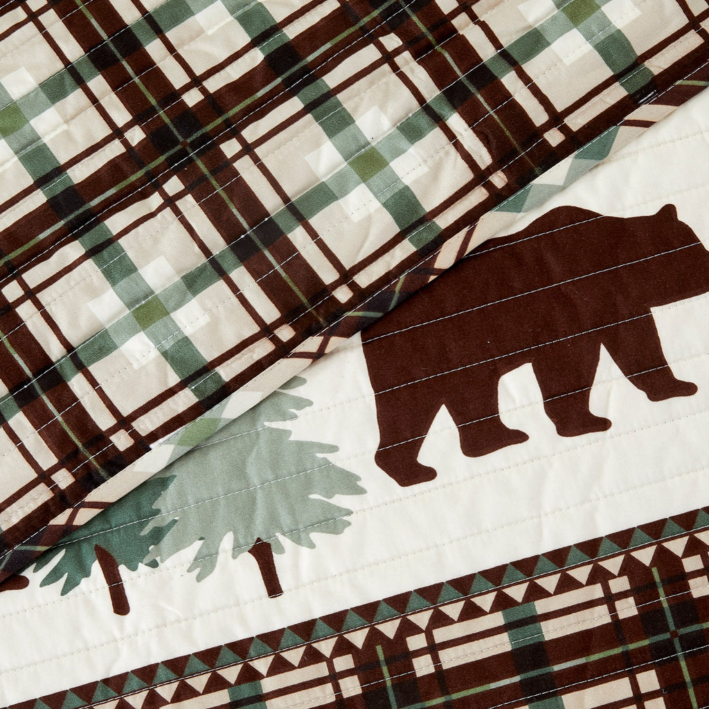 Cedar Creek Collection Lodge Quilt Set featuring rustic woodland-inspired patterns with bears, deer, trees, and plaid accents, shown in multiple colorways and styling views. Soft, reversible bedding with coordinating shams, displayed on beds and in close-up detail shots.