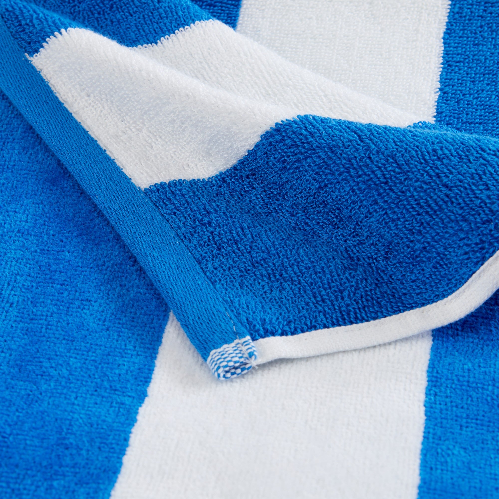Marina Collection cotton cabana stripe beach towels in assorted colors and sizes, featuring classic striped designs and soft, absorbent 100% cotton velour construction, shown folded, stacked, and styled for poolside and beach use.
