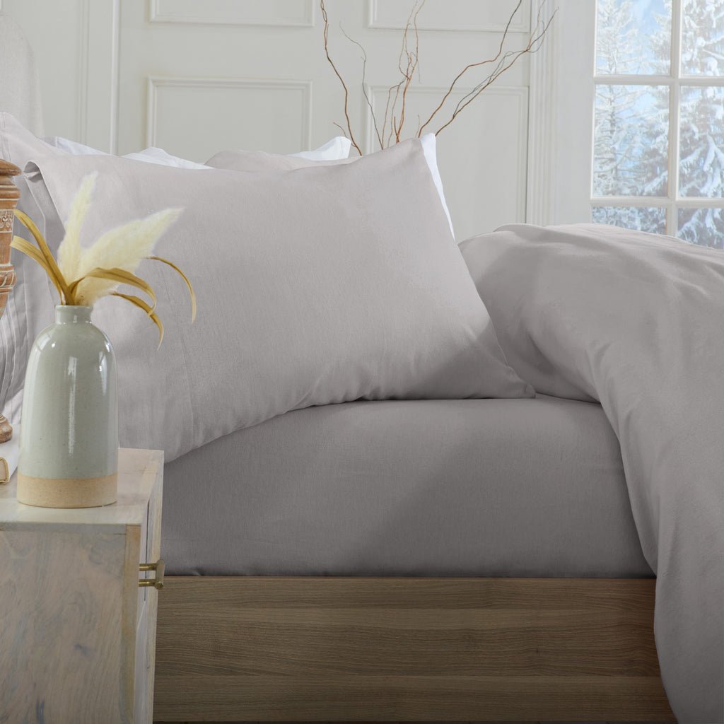 Chalet Collection Solid Flannel Sheet Set in assorted solid colors, featuring ultra-soft 100% Turkish cotton flannel bedding with coordinating pillowcases and fitted sheets, shown styled on beds and folded for detail views.