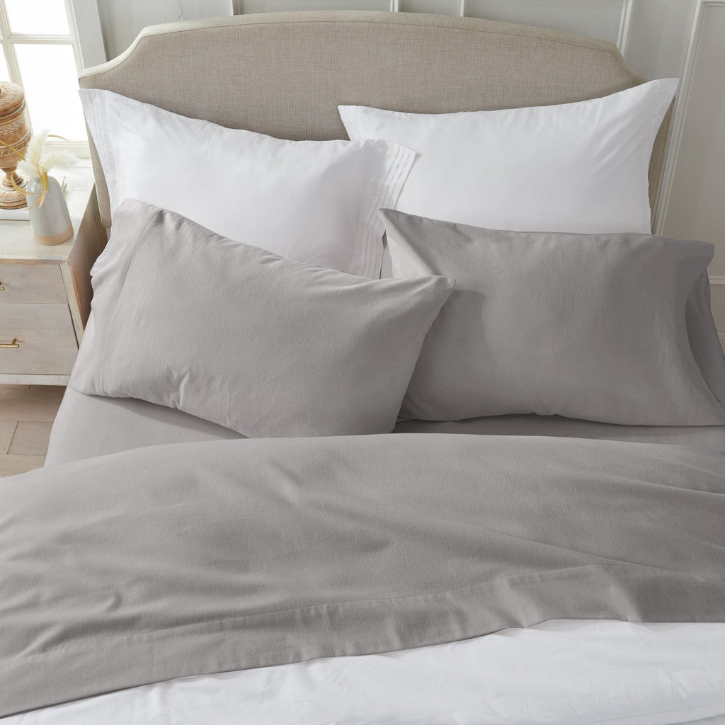 Chalet Collection Solid Flannel Sheet Set in assorted solid colors, featuring ultra-soft 100% Turkish cotton flannel bedding with coordinating pillowcases and fitted sheets, shown styled on beds and folded for detail views.
