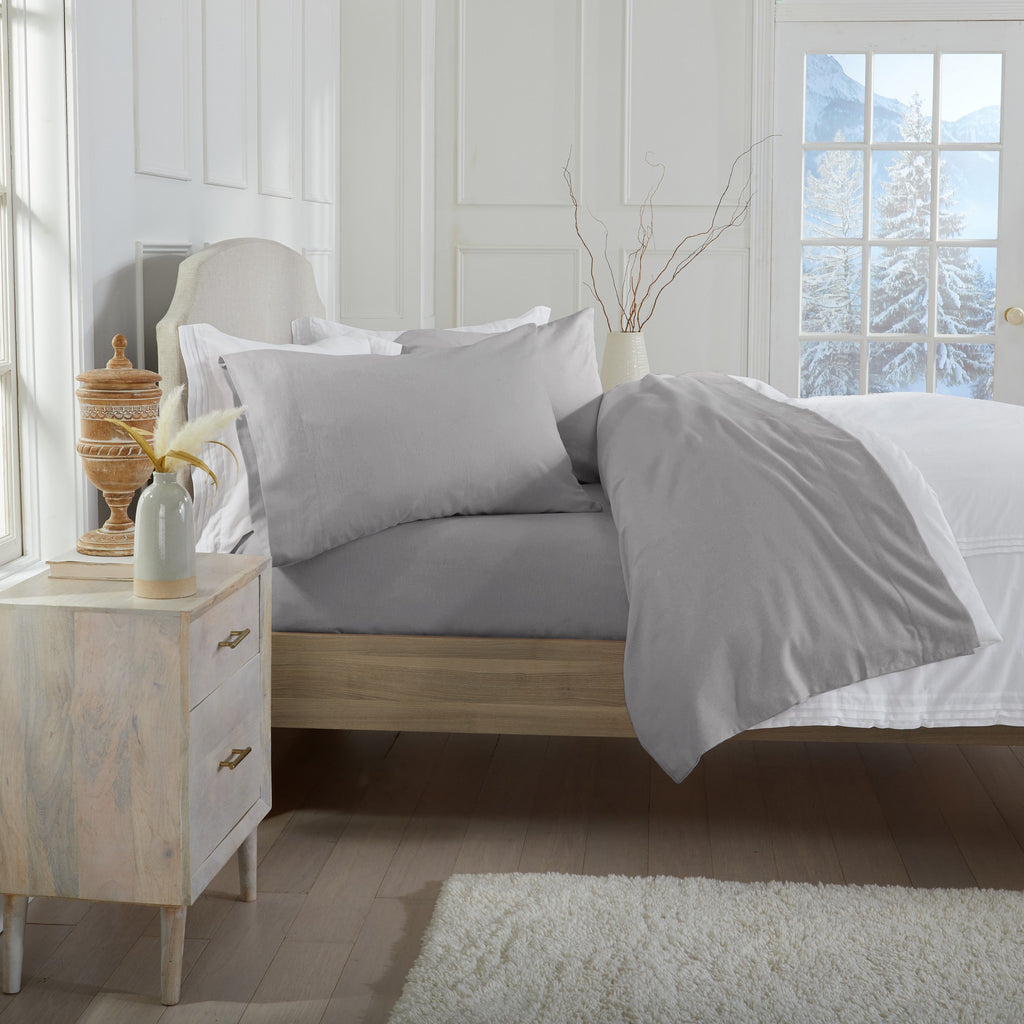 Chalet Collection Solid Flannel Sheet Set in assorted solid colors, featuring ultra-soft 100% Turkish cotton flannel bedding with coordinating pillowcases and fitted sheets, shown styled on beds and folded for detail views.