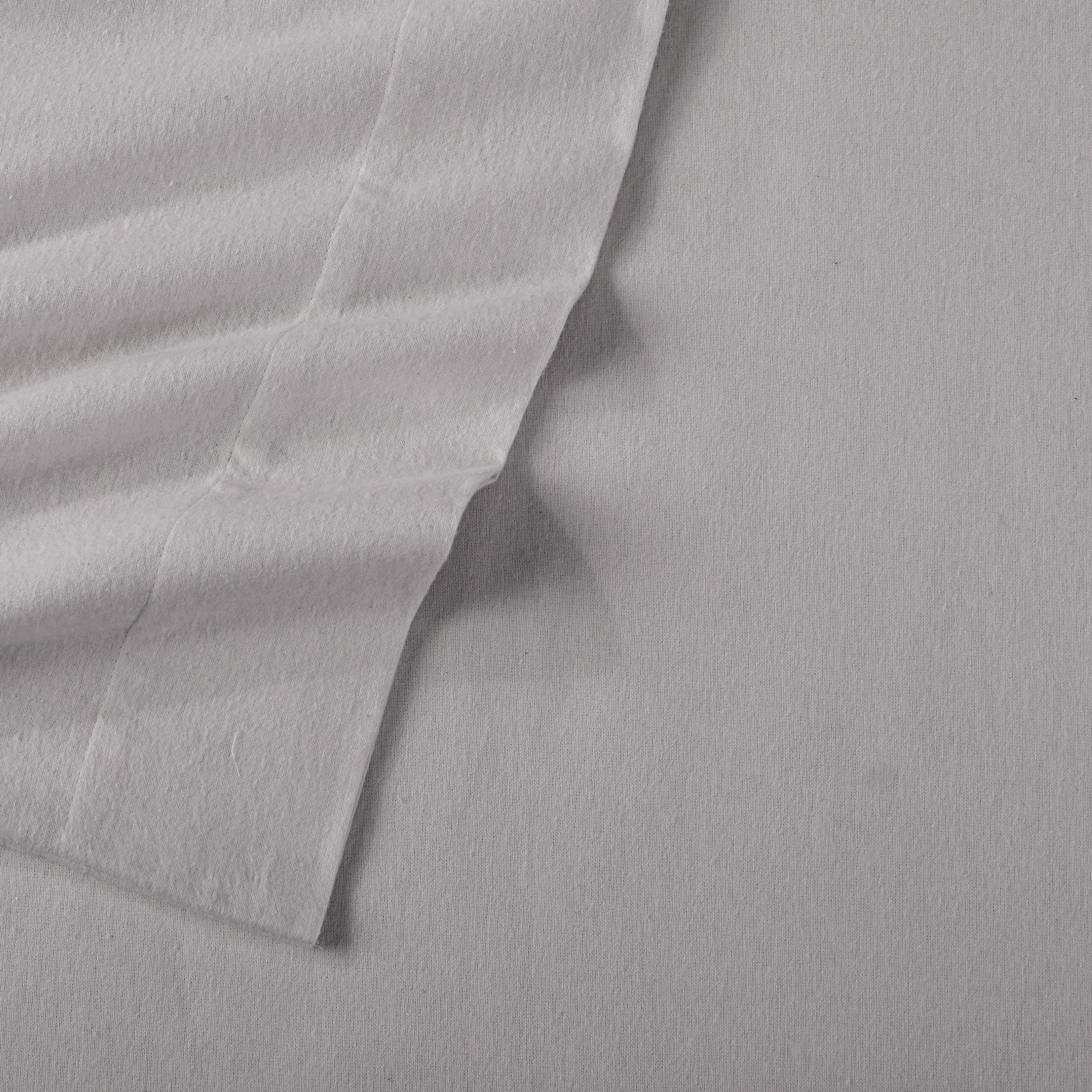 Chalet Collection Solid Flannel Sheet Set in assorted solid colors, featuring ultra-soft 100% Turkish cotton flannel bedding with coordinating pillowcases and fitted sheets, shown styled on beds and folded for detail views.