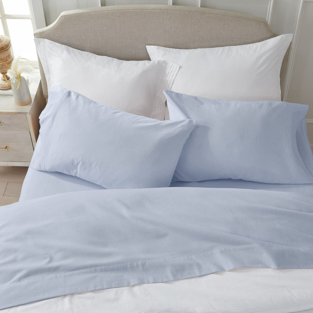 Chalet Collection Solid Flannel Sheet Set in assorted solid colors, featuring ultra-soft 100% Turkish cotton flannel bedding with coordinating pillowcases and fitted sheets, shown styled on beds and folded for detail views.