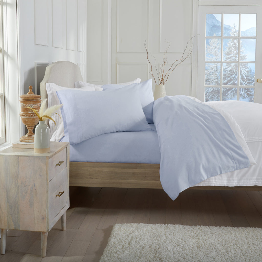 Chalet Collection Solid Flannel Sheet Set in assorted solid colors, featuring ultra-soft 100% Turkish cotton flannel bedding with coordinating pillowcases and fitted sheets, shown styled on beds and folded for detail views.