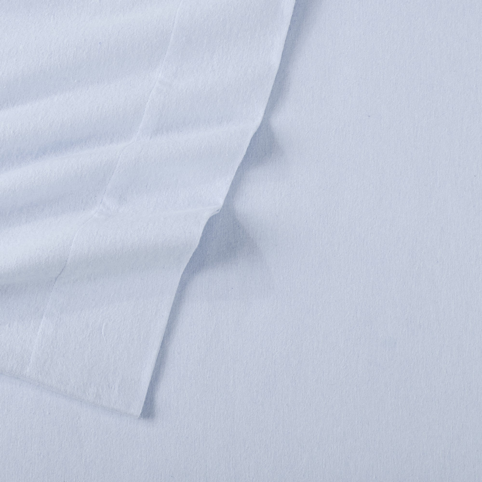 Chalet Collection Solid Flannel Sheet Set in assorted solid colors, featuring ultra-soft 100% Turkish cotton flannel bedding with coordinating pillowcases and fitted sheets, shown styled on beds and folded for detail views.
