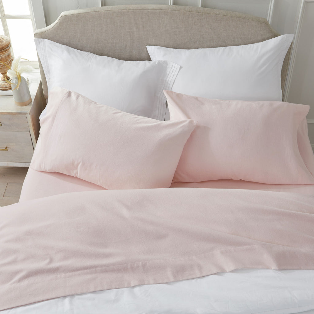 Chalet Collection Solid Flannel Sheet Set in assorted solid colors, featuring ultra-soft 100% Turkish cotton flannel bedding with coordinating pillowcases and fitted sheets, shown styled on beds and folded for detail views.
