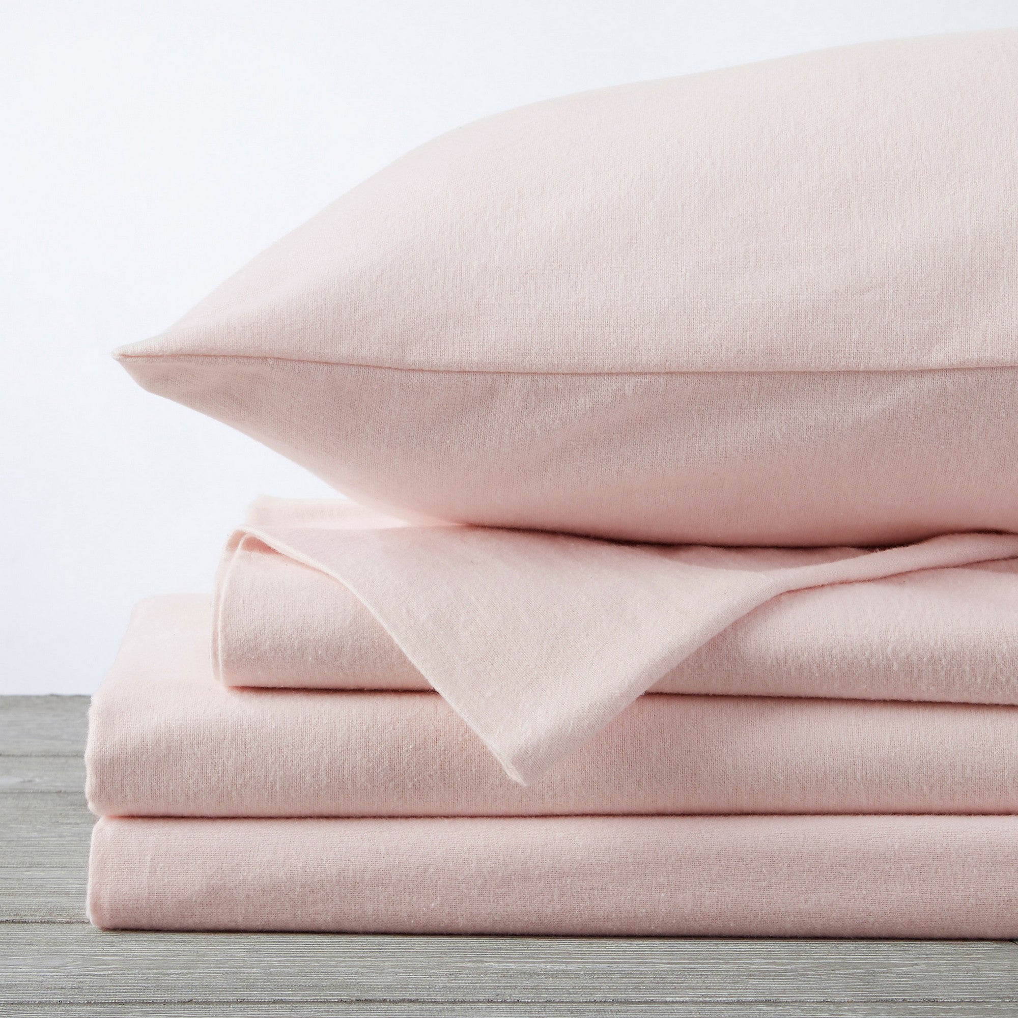 Chalet Collection Solid Flannel Sheet Set in assorted solid colors, featuring ultra-soft 100% Turkish cotton flannel bedding with coordinating pillowcases and fitted sheets, shown styled on beds and folded for detail views.