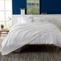 Brielle Collection Cotton Waffle Blanket by Market & Place featuring soft, breathable 100% cotton construction with a classic waffle weave texture. Available in multiple colors and shown folded, layered on beds, and in detailed fabric close-ups, highlighting its lightweight comfort and versatile year-round style.