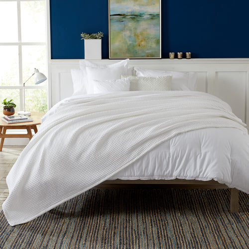 Brielle Collection Cotton Waffle Blanket by Market & Place featuring soft, breathable 100% cotton construction with a classic waffle weave texture. Available in multiple colors and shown folded, layered on beds, and in detailed fabric close-ups, highlighting its lightweight comfort and versatile year-round style.