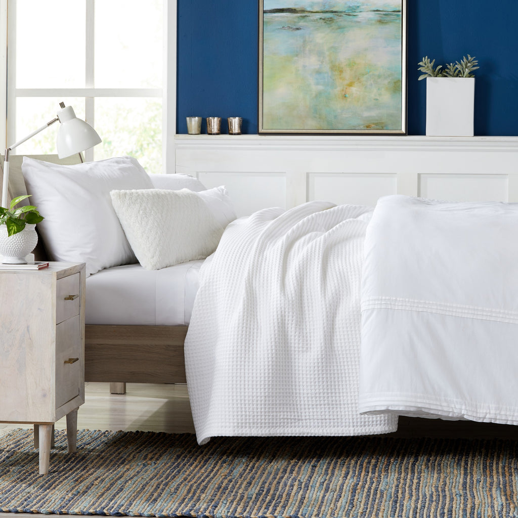 Brielle Collection Cotton Waffle Blanket by Market & Place featuring soft, breathable 100% cotton construction with a classic waffle weave texture. Available in multiple colors and shown folded, layered on beds, and in detailed fabric close-ups, highlighting its lightweight comfort and versatile year-round style.