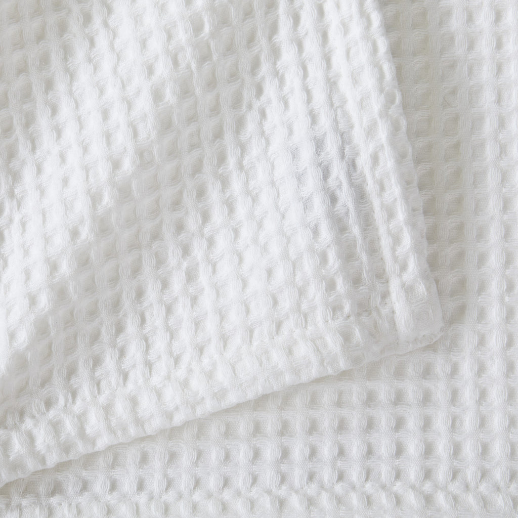 Brielle Collection Cotton Waffle Blanket by Market & Place featuring soft, breathable 100% cotton construction with a classic waffle weave texture. Available in multiple colors and shown folded, layered on beds, and in detailed fabric close-ups, highlighting its lightweight comfort and versatile year-round style.