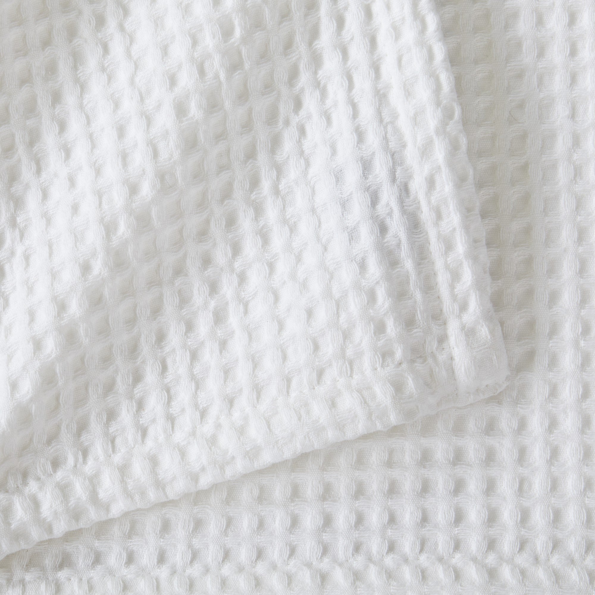 Brielle Collection Cotton Waffle Blanket by Market & Place featuring soft, breathable 100% cotton construction with a classic waffle weave texture. Available in multiple colors and shown folded, layered on beds, and in detailed fabric close-ups, highlighting its lightweight comfort and versatile year-round style.
