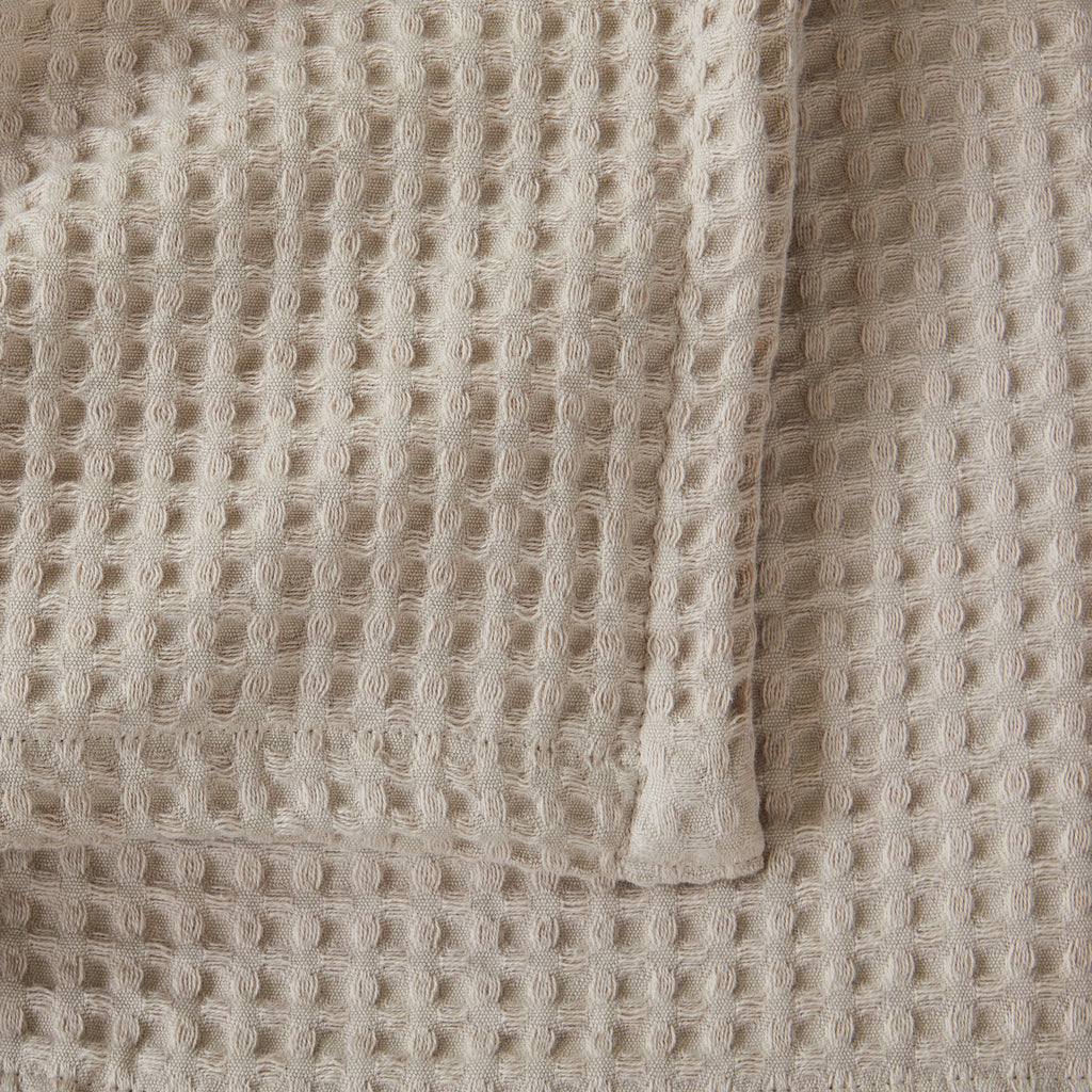 Brielle Collection Cotton Waffle Blanket by Market & Place featuring soft, breathable 100% cotton construction with a classic waffle weave texture. Available in multiple colors and shown folded, layered on beds, and in detailed fabric close-ups, highlighting its lightweight comfort and versatile year-round style.