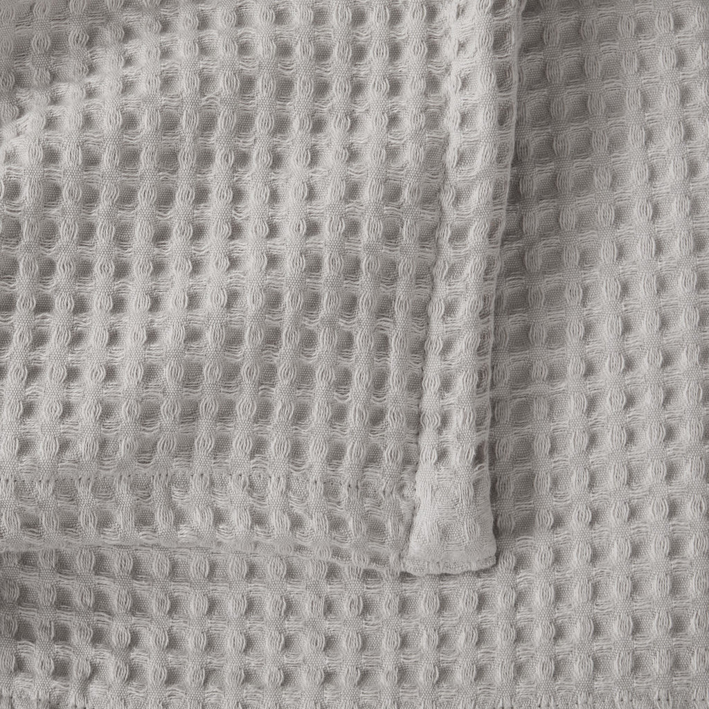 Brielle Collection Cotton Waffle Blanket by Market & Place featuring soft, breathable 100% cotton construction with a classic waffle weave texture. Available in multiple colors and shown folded, layered on beds, and in detailed fabric close-ups, highlighting its lightweight comfort and versatile year-round style.